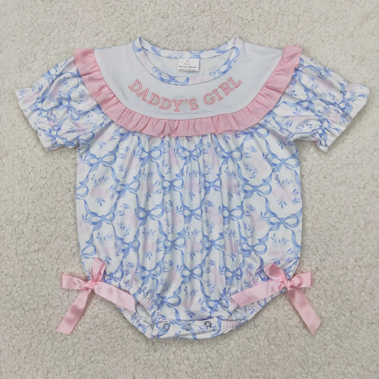 Girl's camo print romper by Lavendar Lane Clothing featuring embroidery, bows, and ruffles in a playful design.