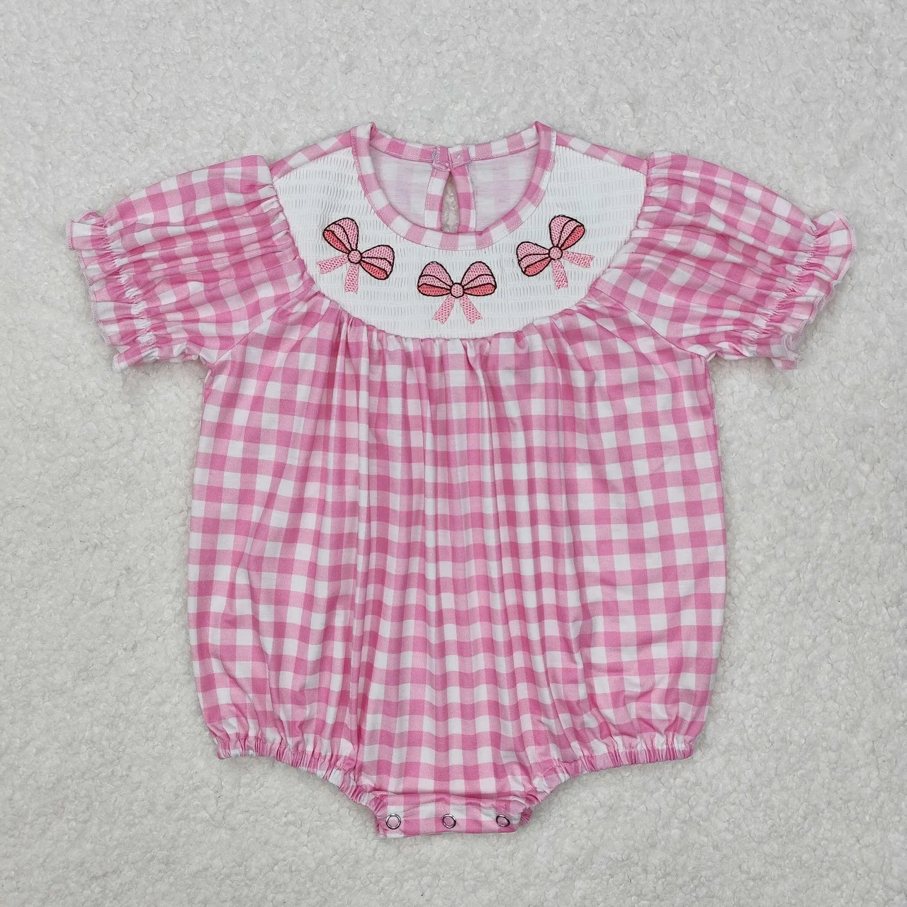 Girl's camo print romper by Lavendar Lane Clothing featuring embroidery, bows, and ruffles for a stylish look.