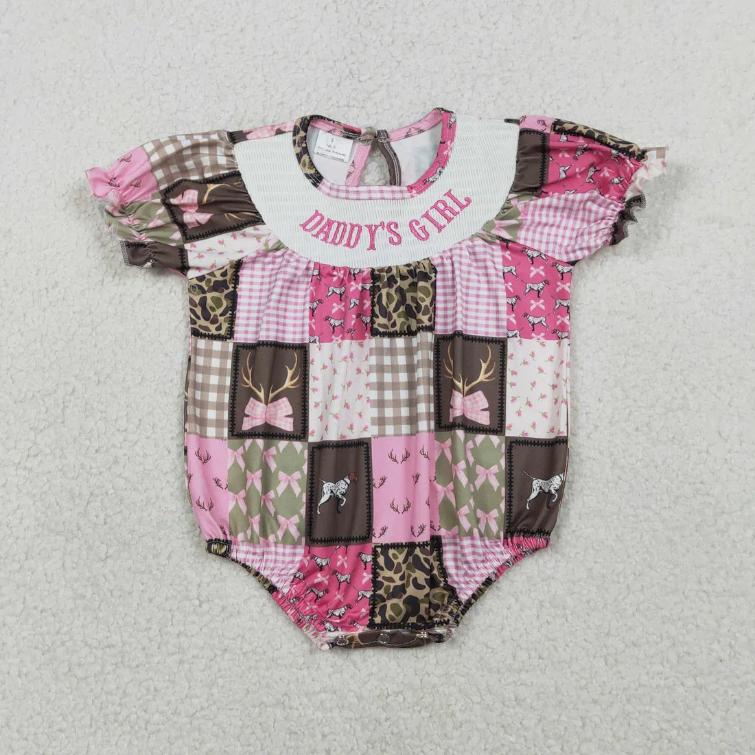 Girl's camo print romper by Lavendar Lane Clothing featuring embroidery, bows, and ruffles.