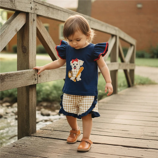 Toddler girl’s summer 2-piece outfit with flying sleeve O-neck dog embroidery tops and plaid shorts by Lavender Lane Clothing.