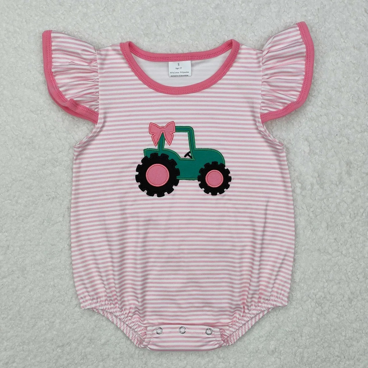 Girl's camo print romper by Lavendar Lane Clothing featuring embroidery, bows, and ruffles.