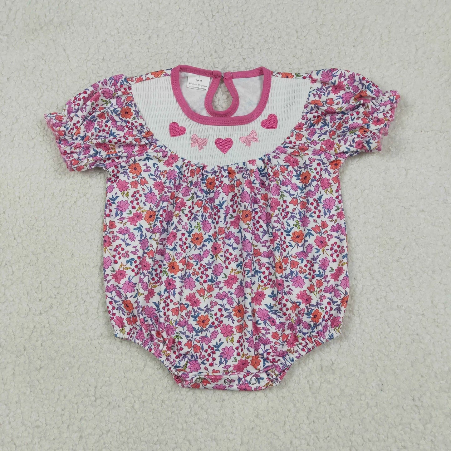 Girl's camo print romper by Lavendar Lane Clothing featuring embroidery, bows, and ruffles.