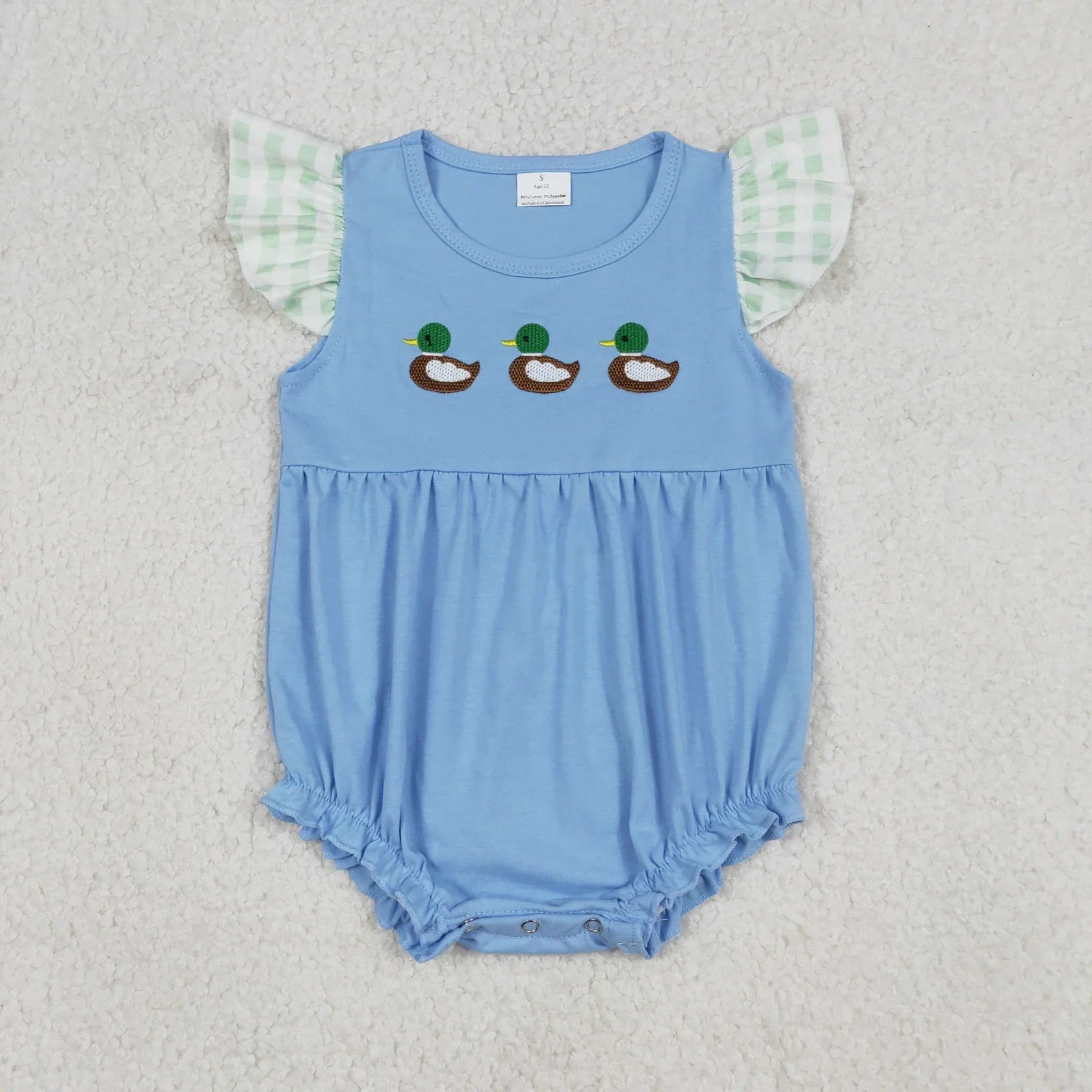 Girl's camo print romper by Lavendar Lane Clothing featuring embroidery, bows, and ruffles for a playful look.