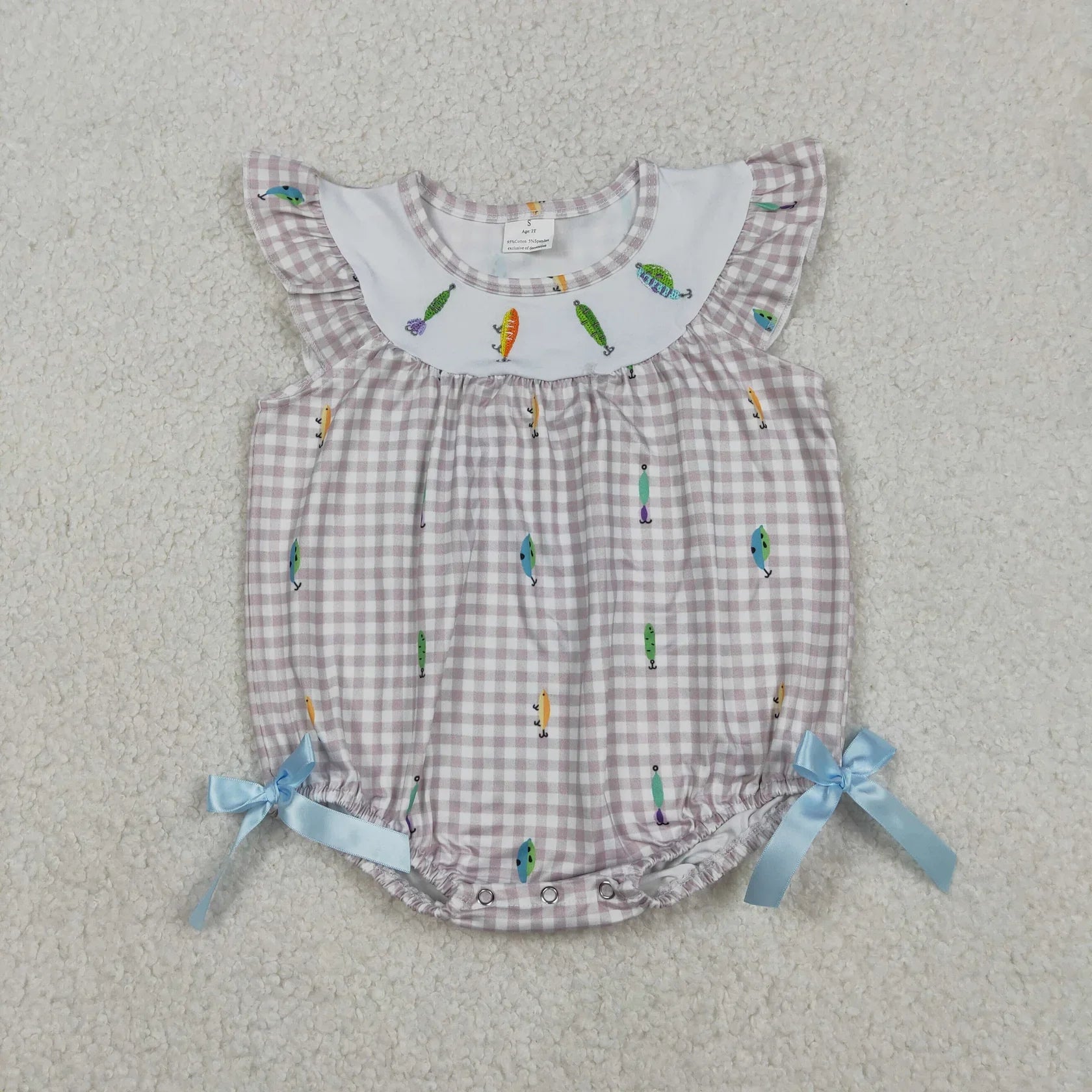 Girl's camo print romper by Lavendar Lane Clothing featuring embroidery, bows, and ruffles for a stylish look.