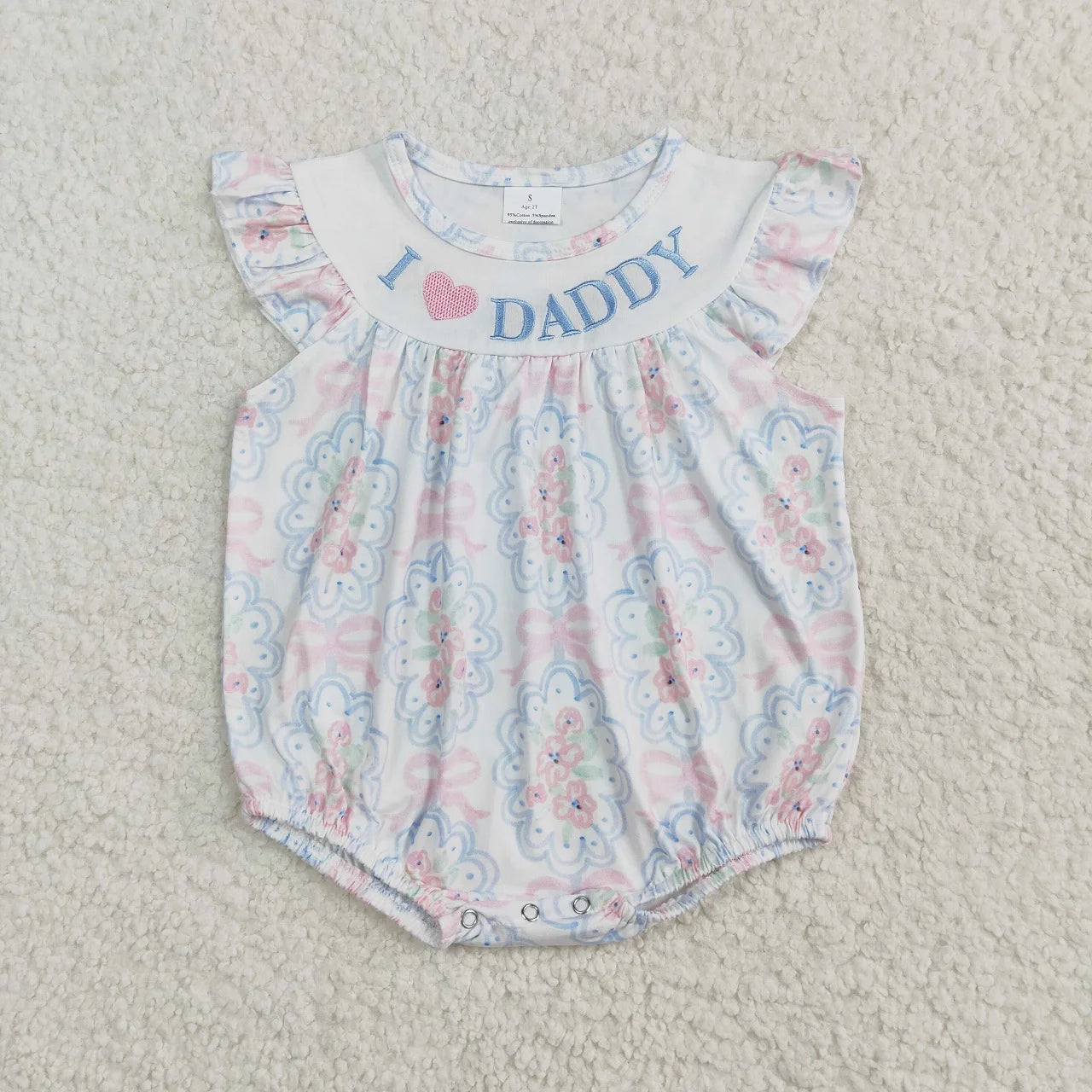 Girl's camo print romper by Lavendar Lane Clothing featuring embroidery, bows, and ruffles.