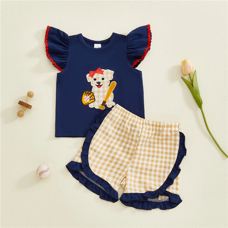 Toddler girl’s summer 2-piece outfit with embroidered dog tops and plaid shorts from Lavender Lane Clothing.
