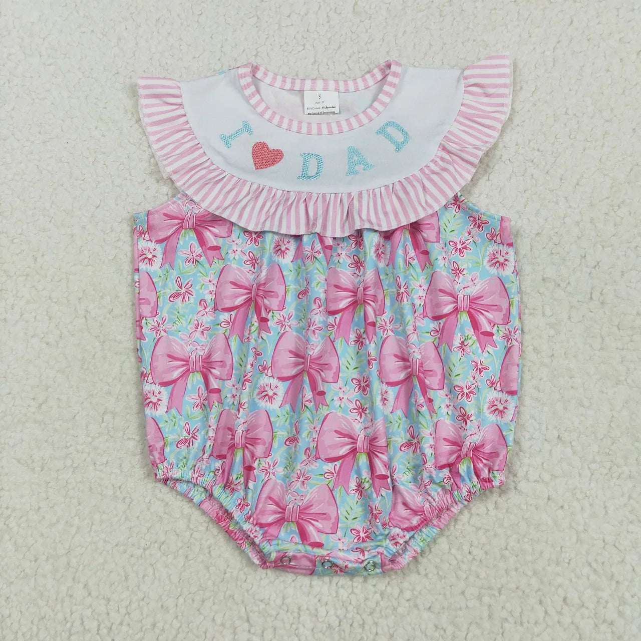 Girl's camo print romper by Lavendar Lane Clothing, featuring embroidery, bows, and ruffles for a stylish look.