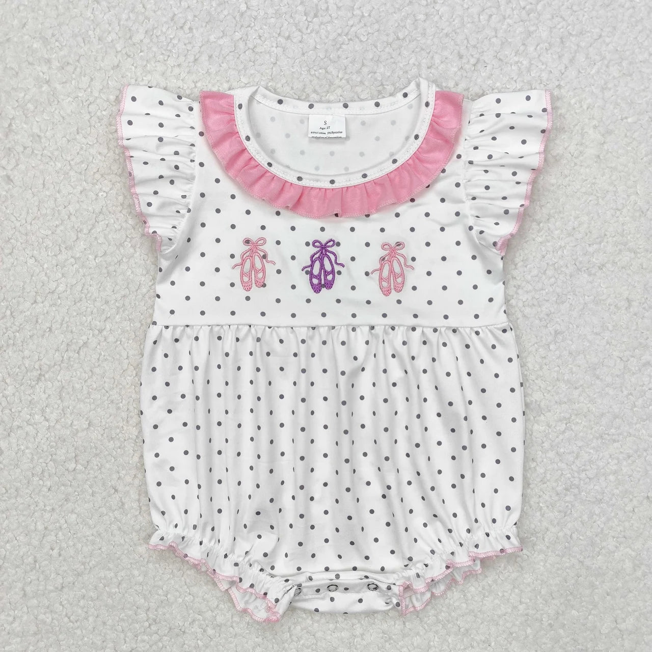 Girl's camo print romper by Lavendar Lane Clothing featuring embroidery, bows, and ruffles.