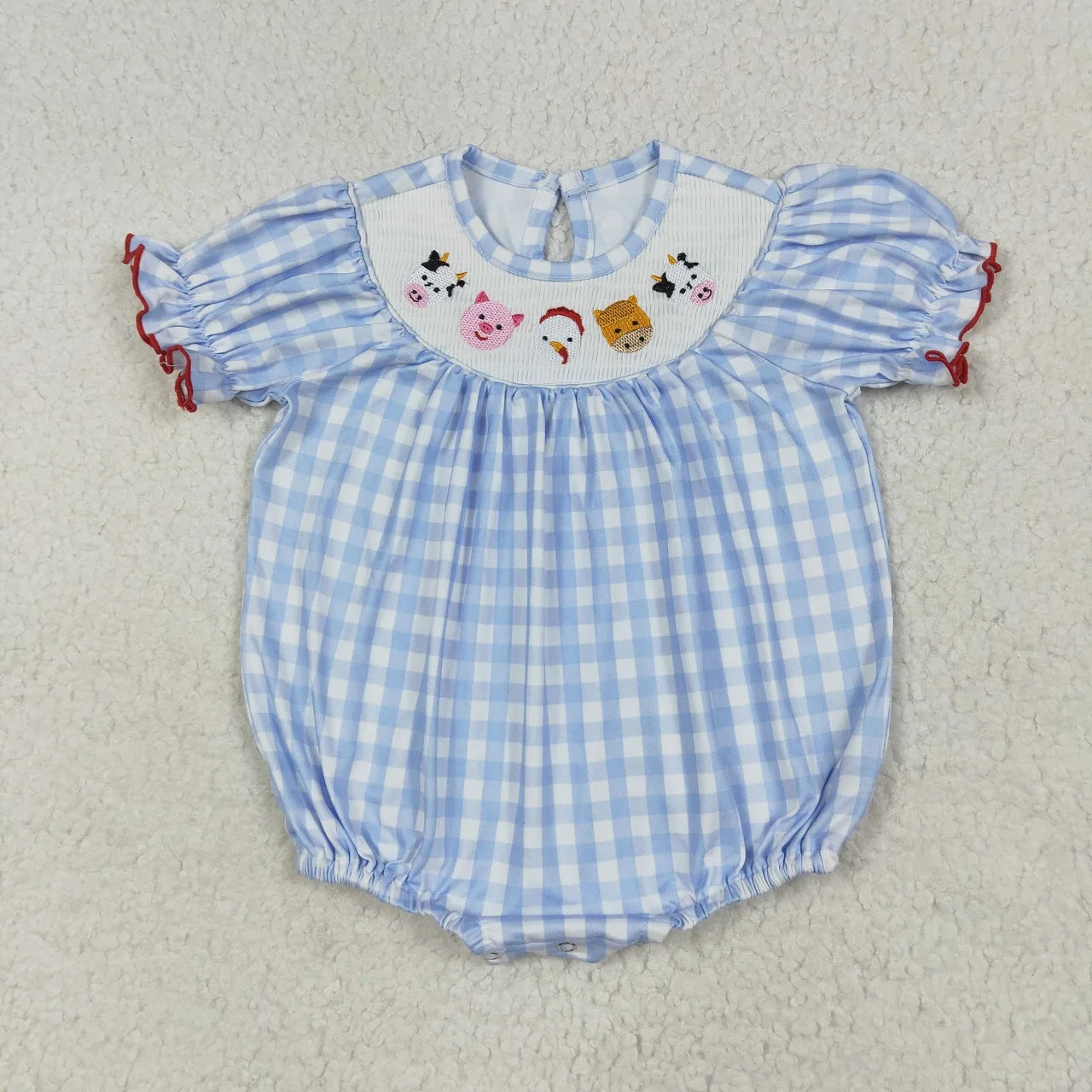 Girl's camo print romper by Lavendar Lane Clothing featuring embroidery, bows, and ruffles for a stylish look.