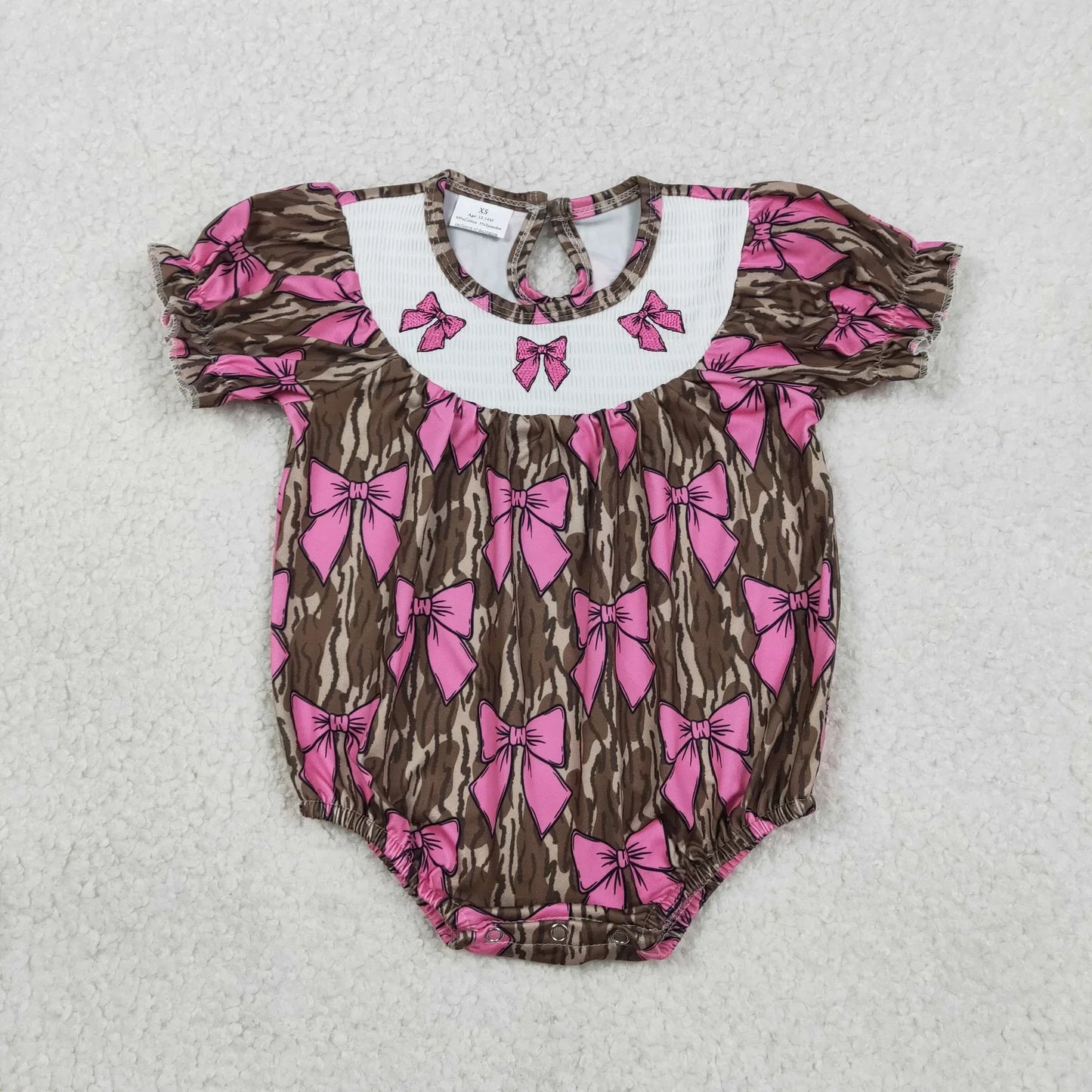 Girl's camo print romper by Lavendar Lane Clothing featuring embroidery, bows, and ruffles.