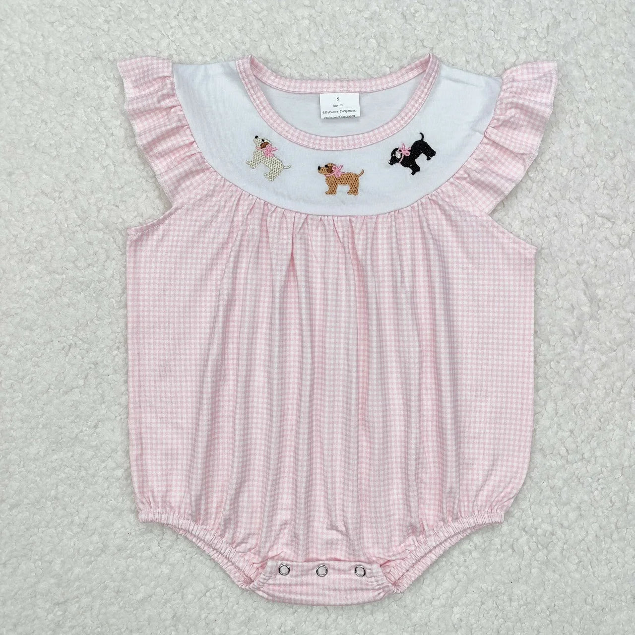 Girl's camo print romper by Lavendar Lane Clothing with embroidery, bows, and ruffles, featuring a playful design.