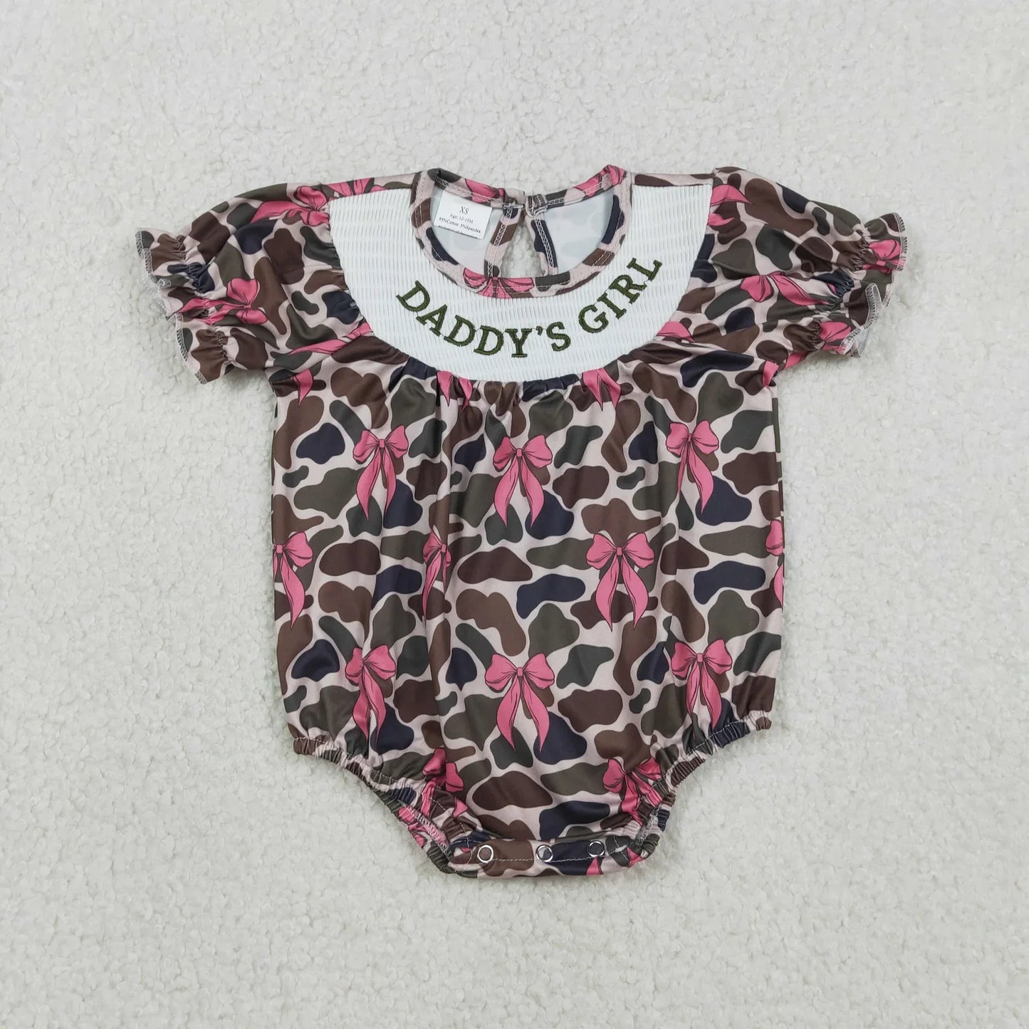 Girl's camo print romper by Lavendar Lane Clothing featuring bows and ruffles for a stylish look.