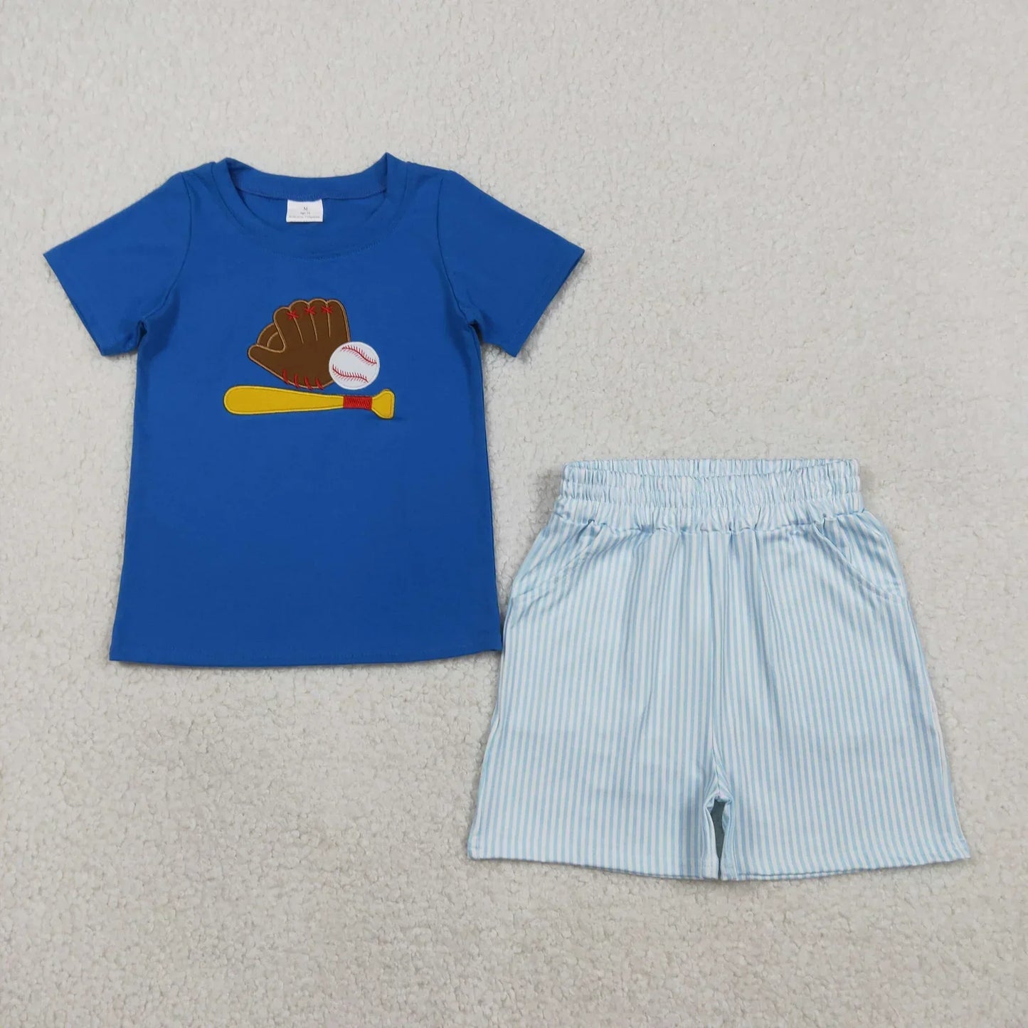 Boy's short sleeve shirt and shorts set from Lavendar Lane Clothing in blue with playful patterns and comfortable fit.