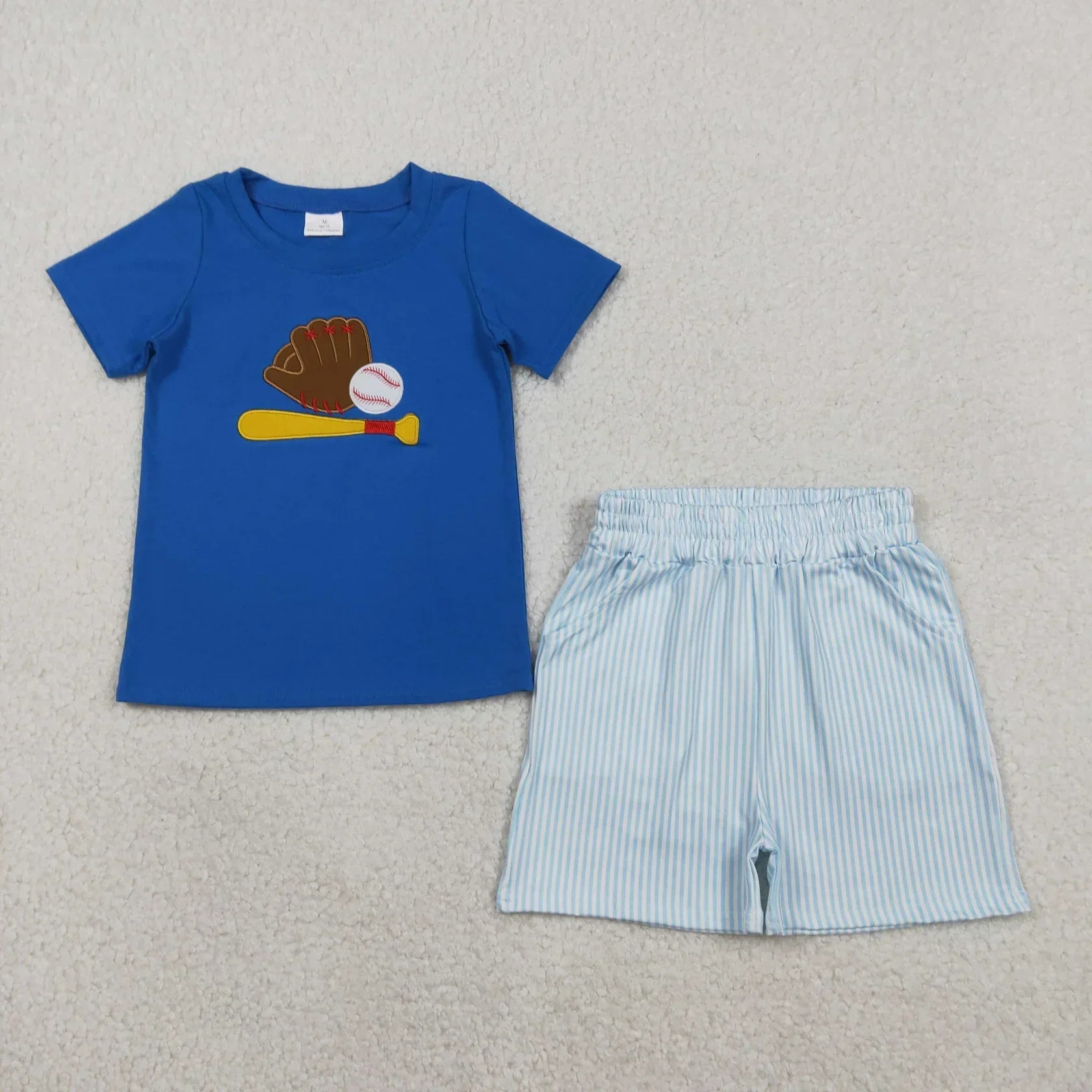 Boy's short sleeve shirt and shorts set from Lavendar Lane Clothing in blue with playful patterns and comfortable fit.