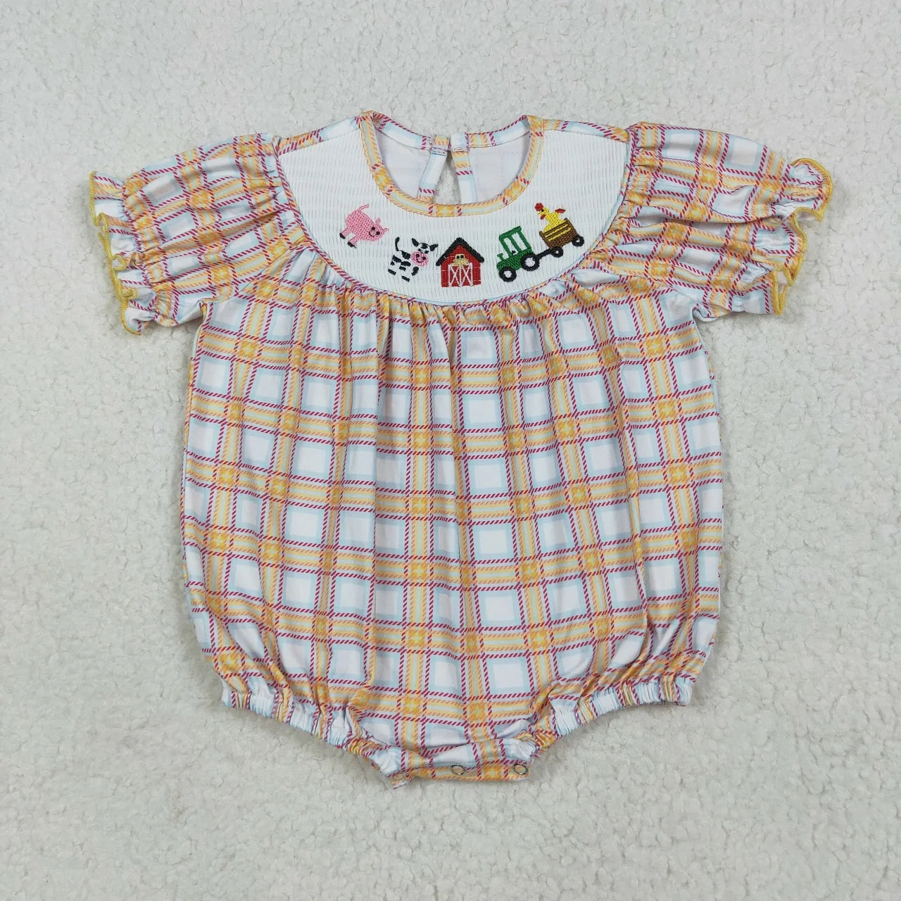 Girl's camo print romper by Lavendar Lane Clothing featuring embroidery, bows, and ruffles, perfect for playful outfits.