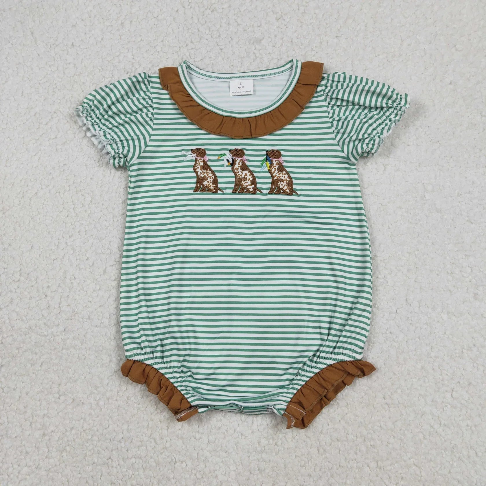 Girl's camo print romper by Lavendar Lane Clothing featuring embroidery, bows, and ruffles for a stylish look.