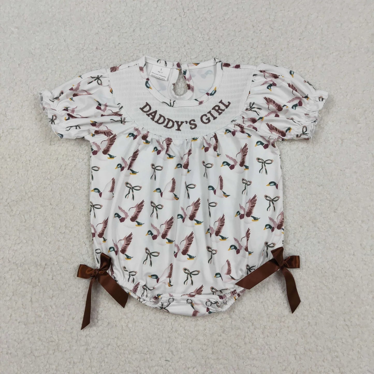 Girl's camo print romper by Lavendar Lane Clothing featuring embroidery, bows, and ruffles.