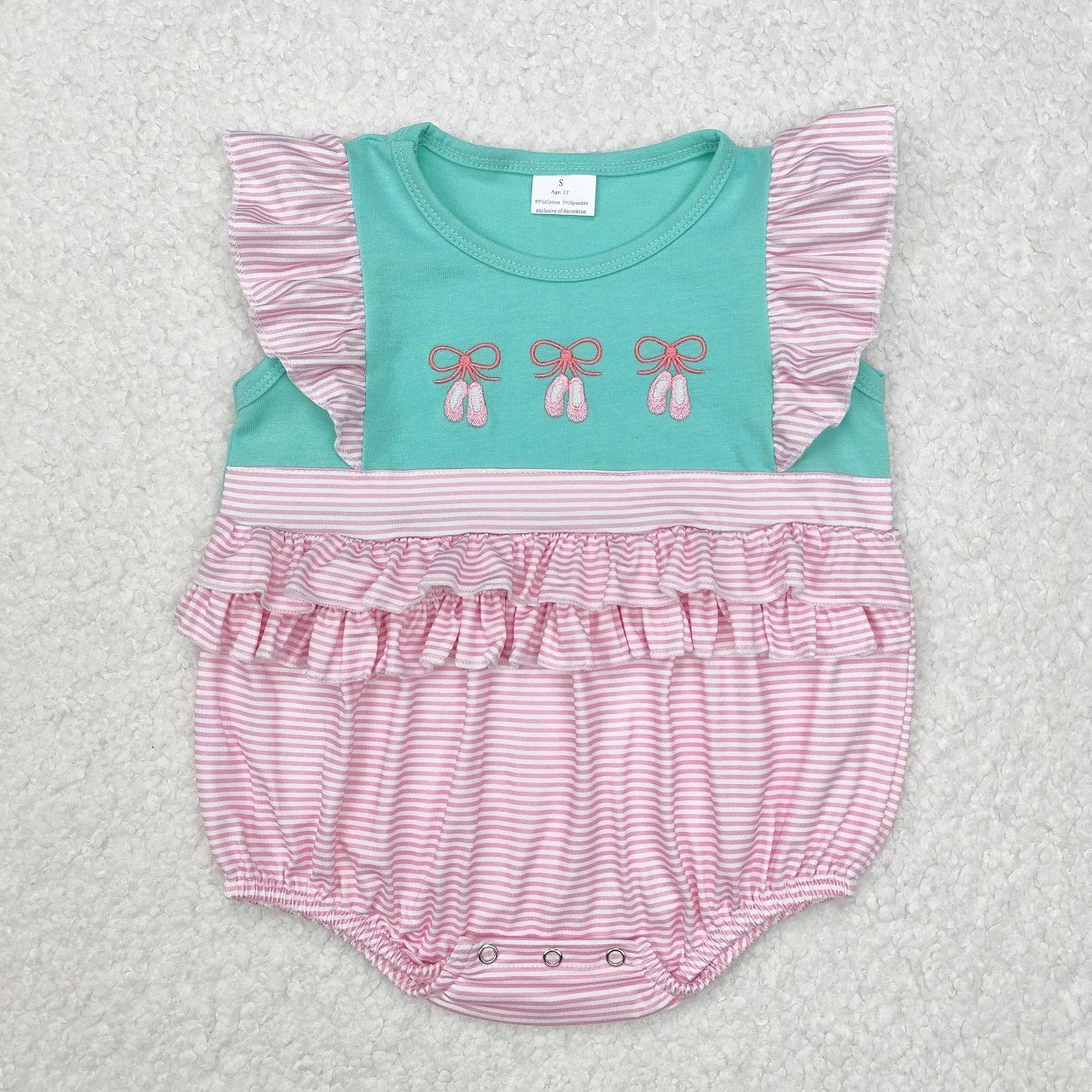 Girl's camo print romper from Lavendar Lane Clothing featuring embroidery, bows, and ruffles.