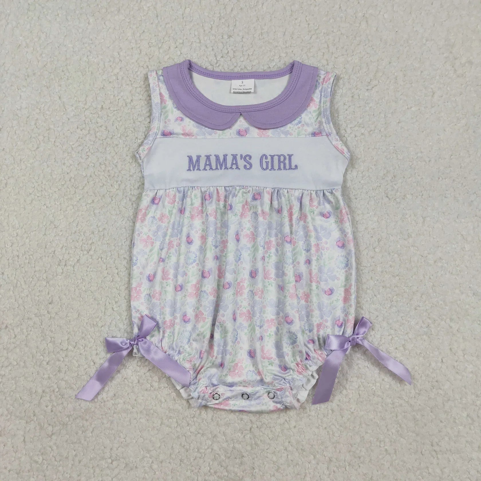 Girl's camo print romper by Lavendar Lane Clothing featuring embroidered details, bows, and ruffles.