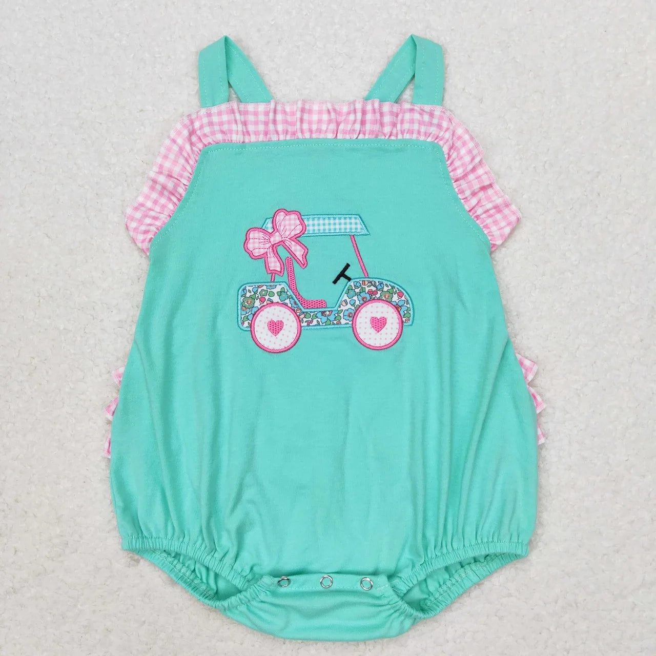 Girl's camo print romper by Lavendar Lane Clothing featuring embroidery, bows, and ruffles for a stylish look.