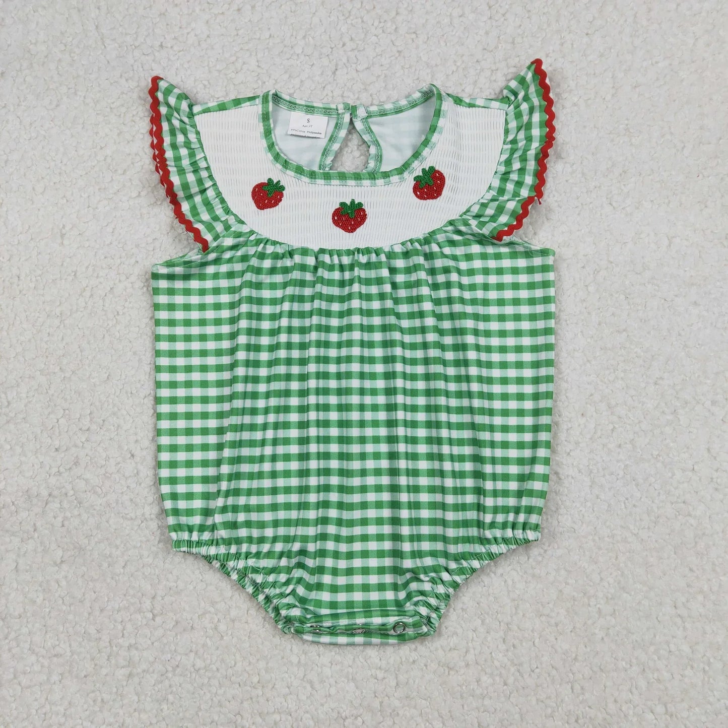 Girl's camo print romper by Lavendar Lane Clothing featuring embroidery, bows, and ruffles.