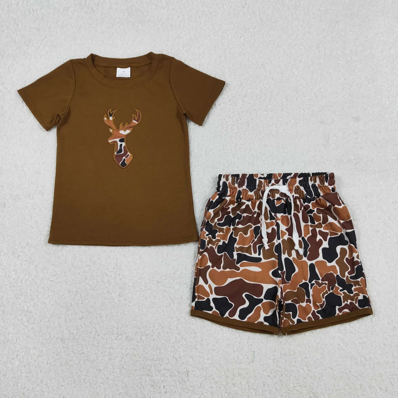 Lavendar Lane Clothing boy's short sleeve shorts set featuring a colorful design on a light background.
