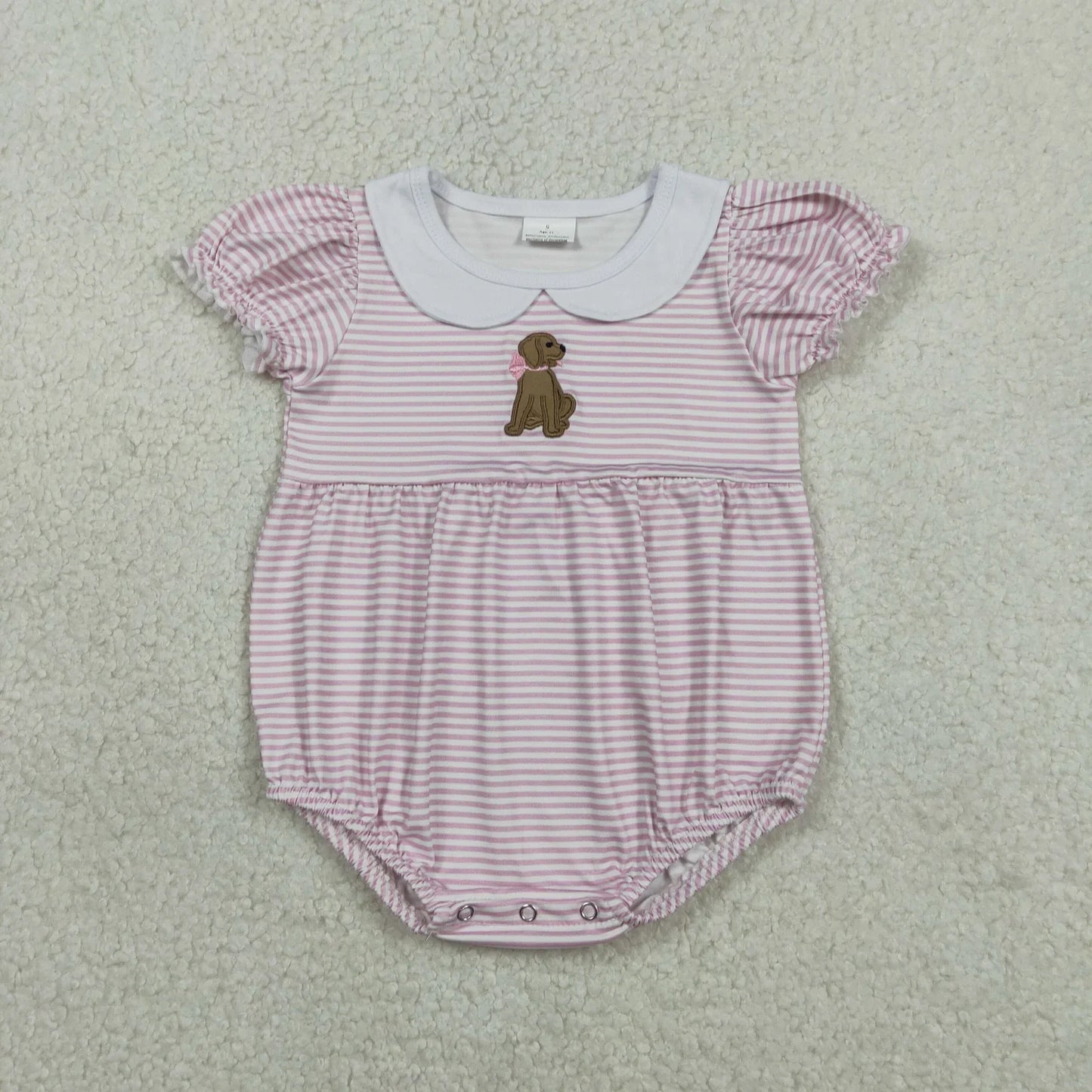 Girl's camo print romper by Lavendar Lane Clothing featuring embroidery, bows, and ruffles.