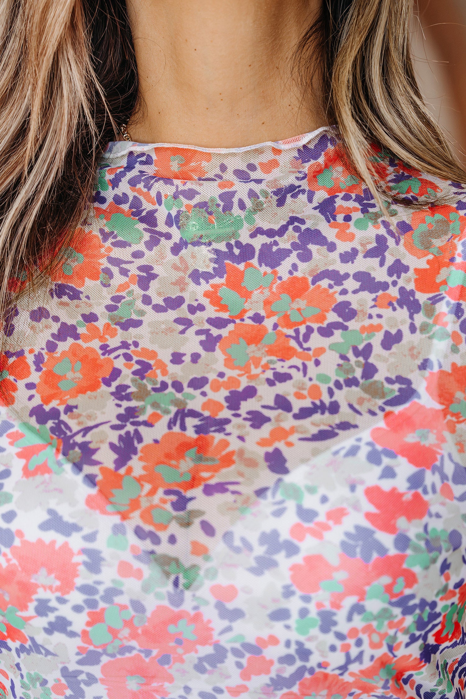 Blue slim fit floral mesh long sleeve mock neck top by Lavender Lane Clothing, featuring a stylish floral pattern and fitted design.