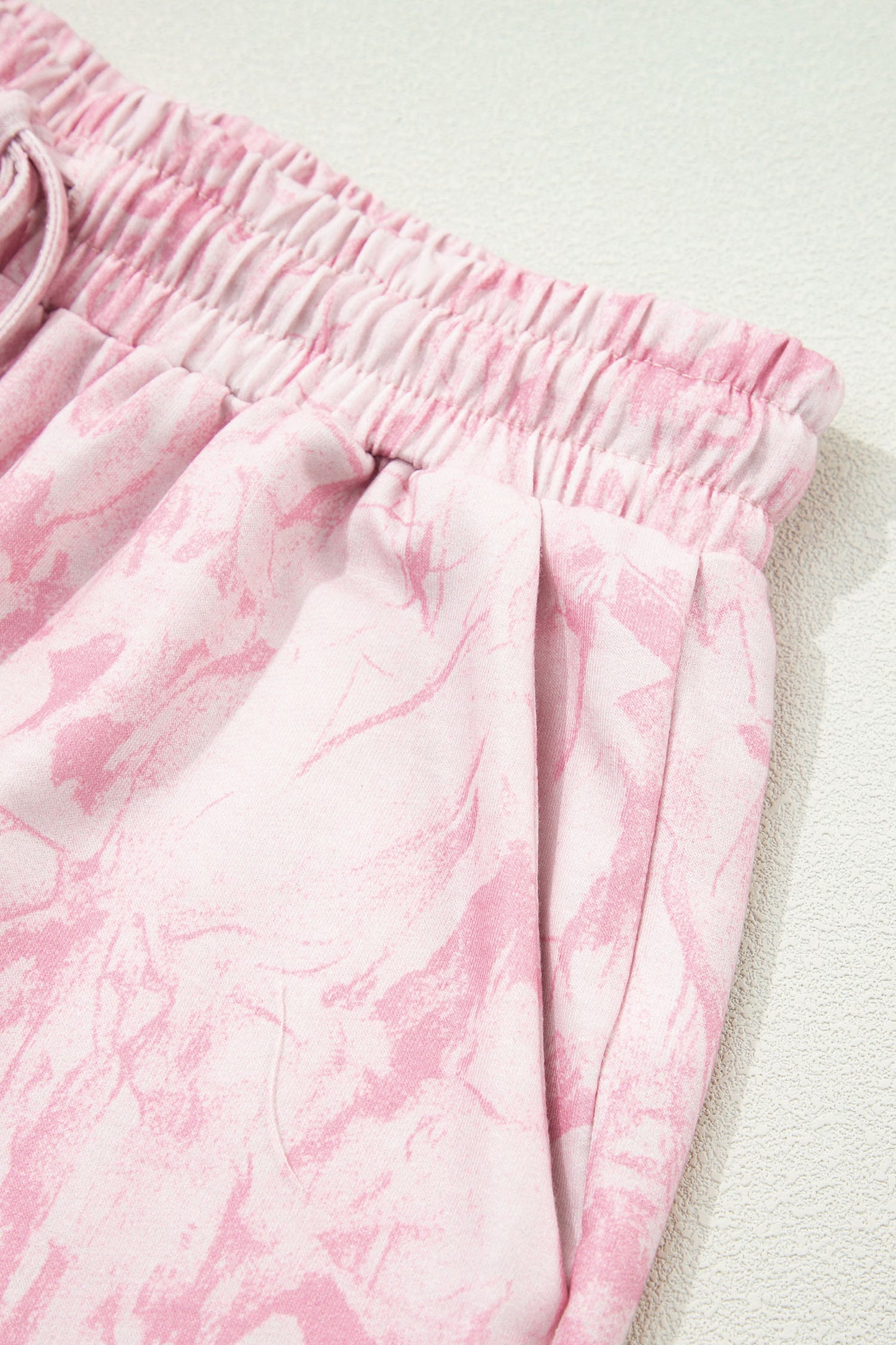 Pink abstract print V-neck loose T-shirt and drawstring shorts in a two-piece set by Lavendar Lane Clothing.