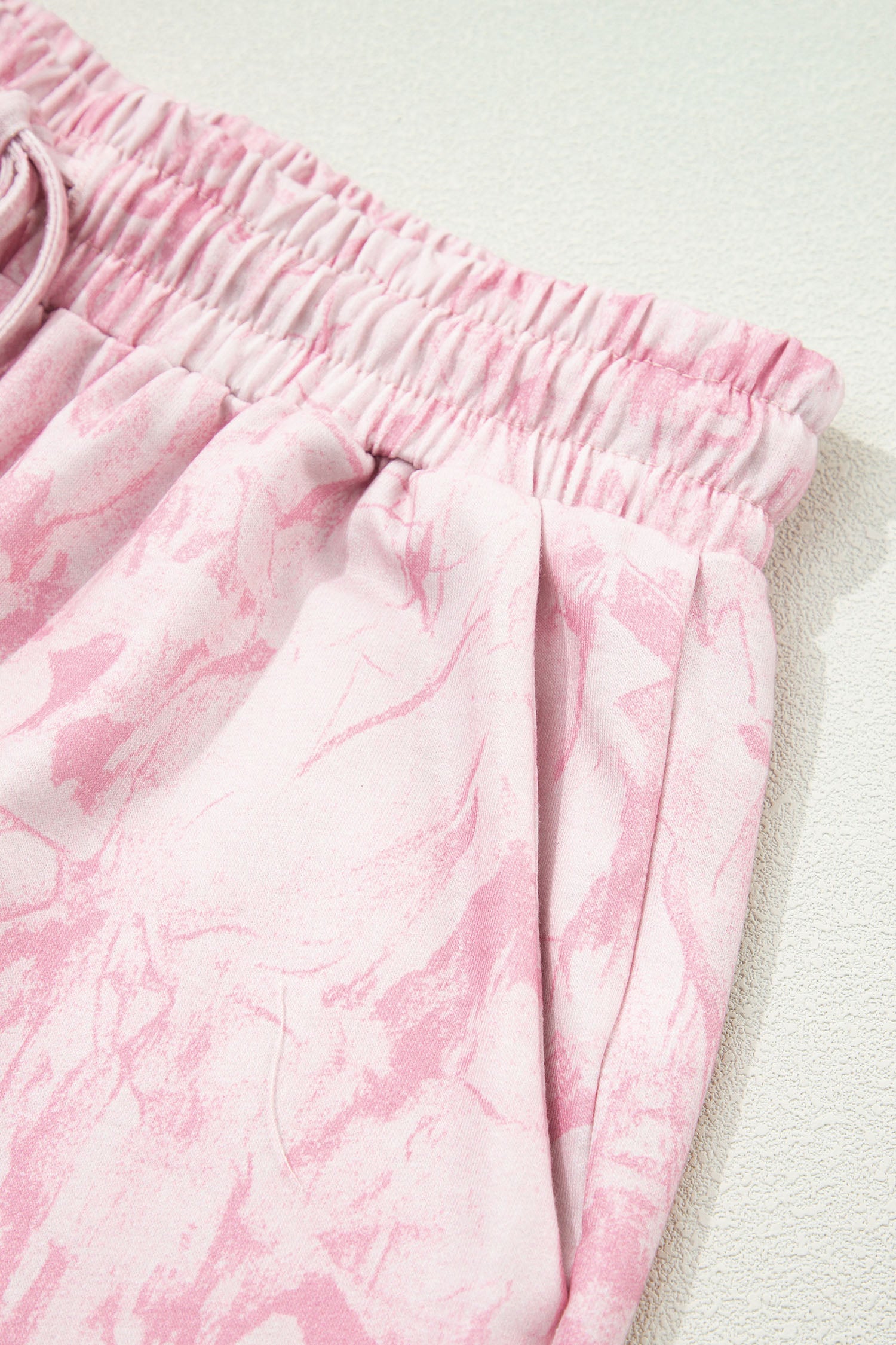 Pink abstract print V-neck loose T-shirt and drawstring shorts in a two-piece set by Lavendar Lane Clothing.