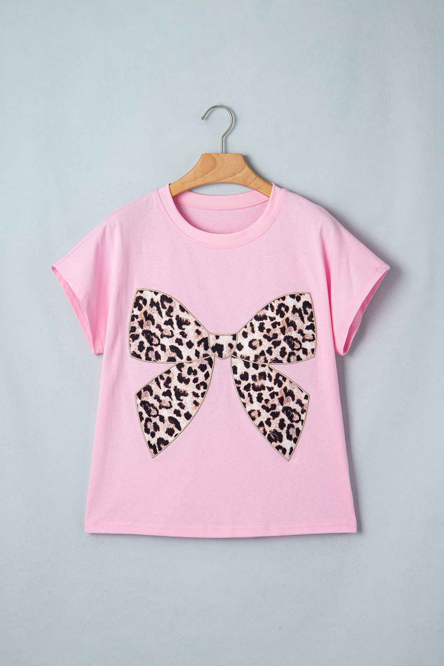 Pink leopard print embroidered cotton round neck T-shirt from Lavendar Lane Clothing, featuring a bow detail and casual fit.