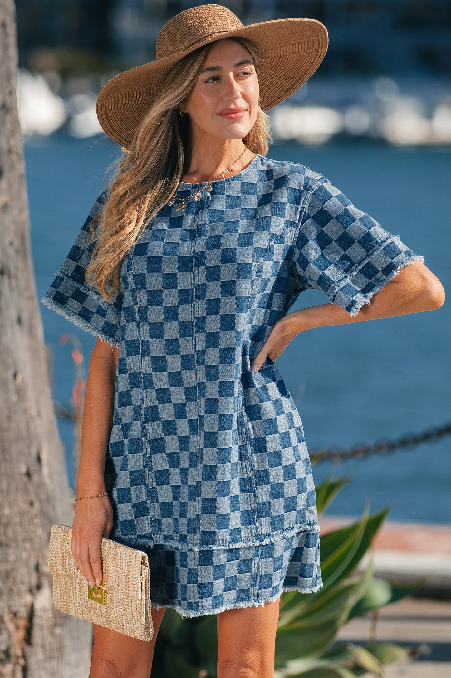 Sky blue checkered denim mini dress with frayed hem from Lavendar Lane Clothing, featuring a casual, stylish design.