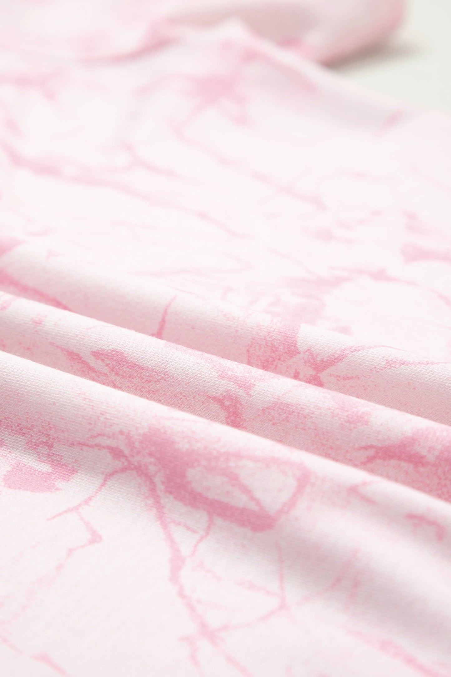 Pink abstract print V-neck loose tee with drawstring shorts, two-piece set from Lavendar Lane Clothing, casual summer outfit.