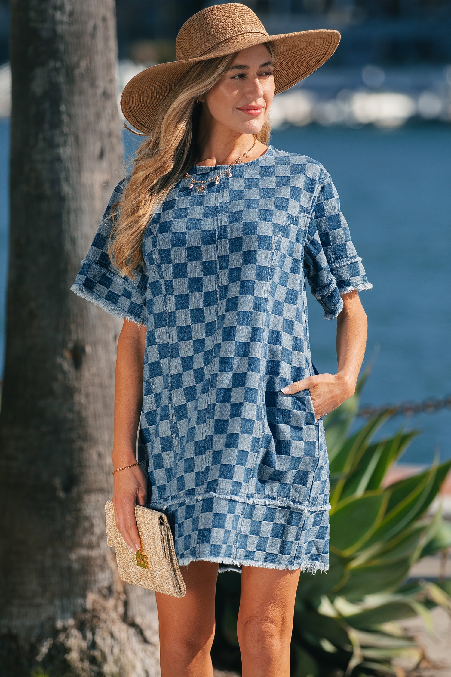 Sky blue checkered denim mini dress with frayed hem by Lavendar Lane Clothing, featuring a stylish, casual design.