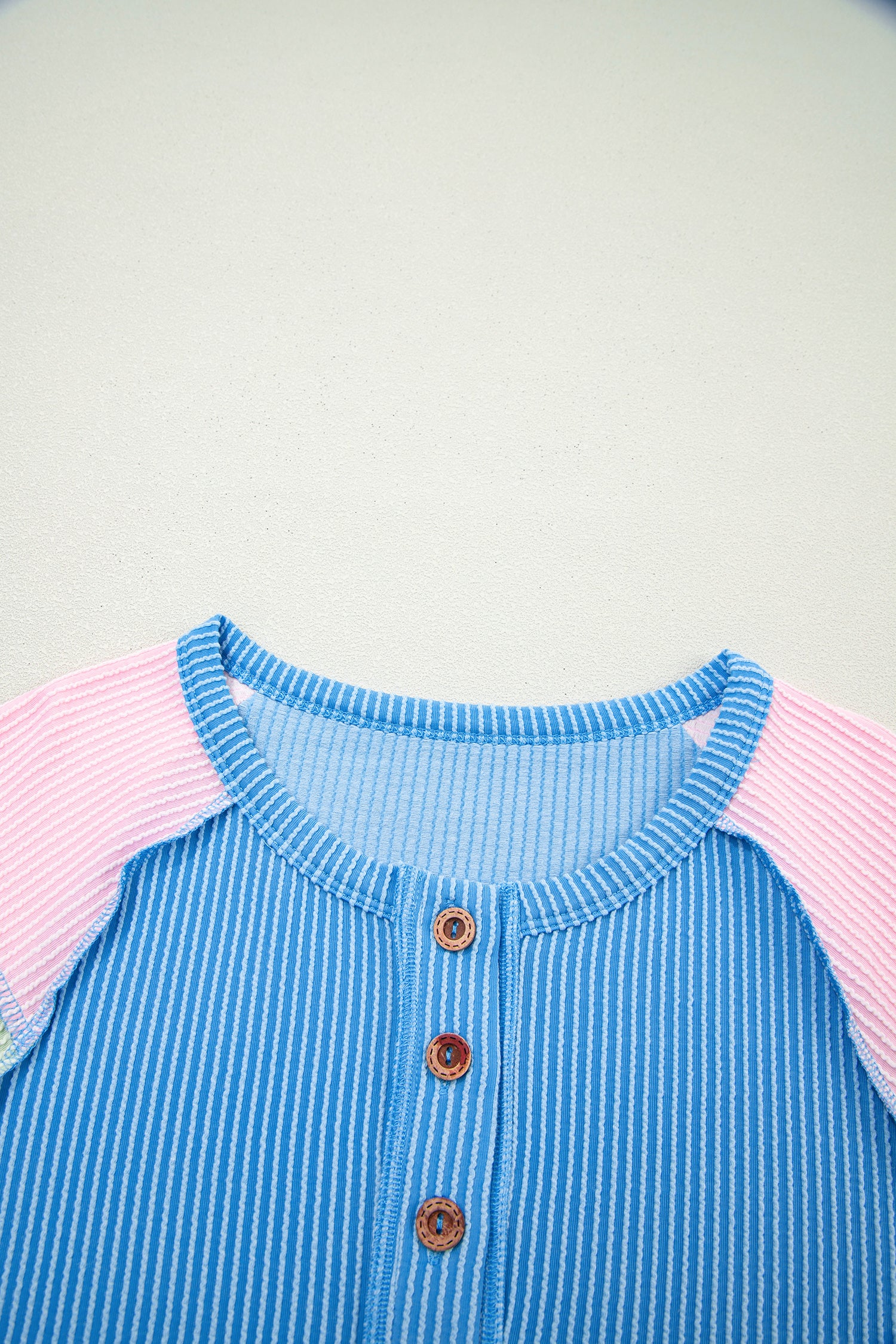 Blue twisted ribbed color block patchwork henley blouse from Lavender Lane Clothing, featuring short sleeves and a stylish design.
