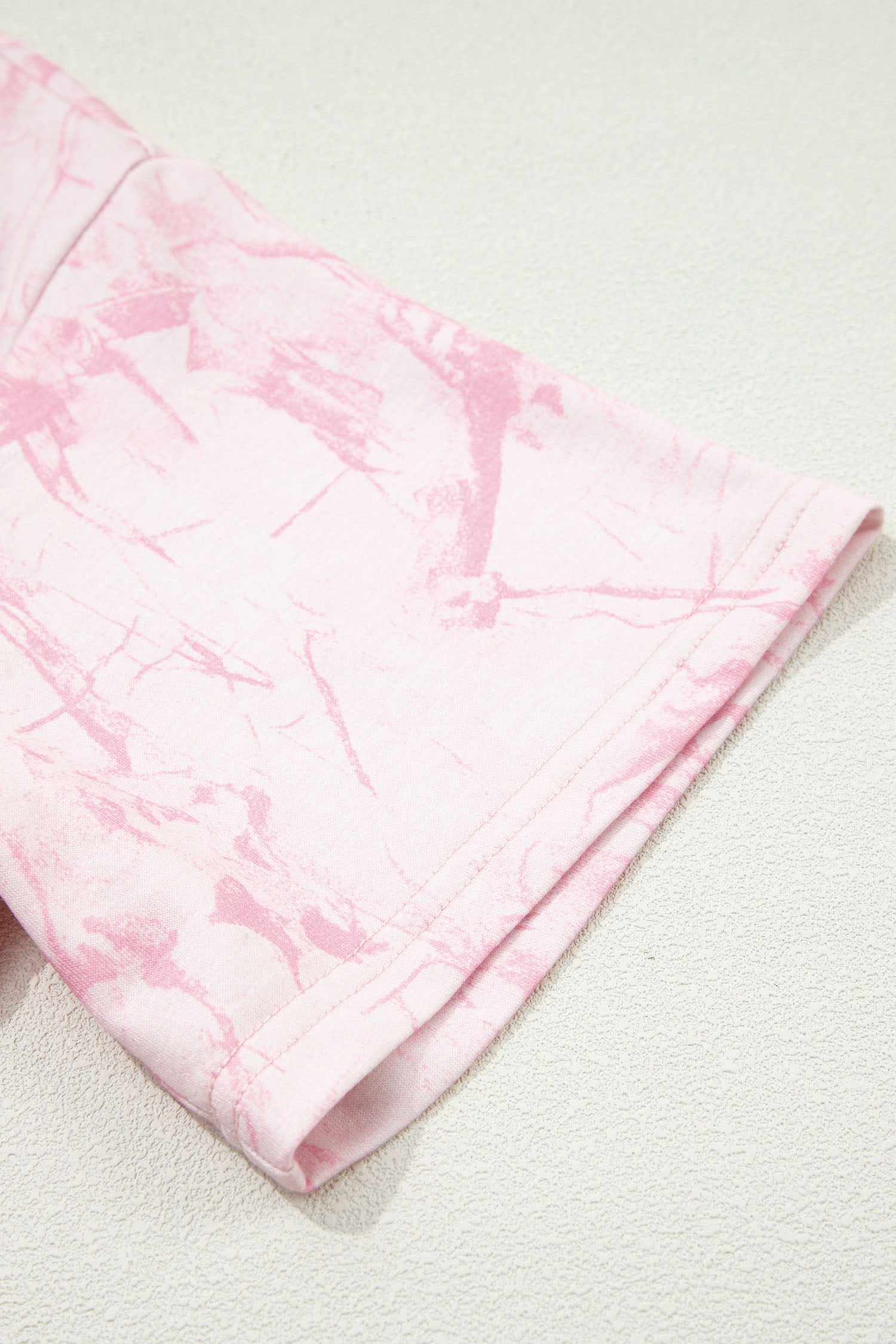 Pink abstract print V-neck loose tee with drawstring shorts, two-piece set by Lavendar Lane Clothing, casual and comfortable outfit.