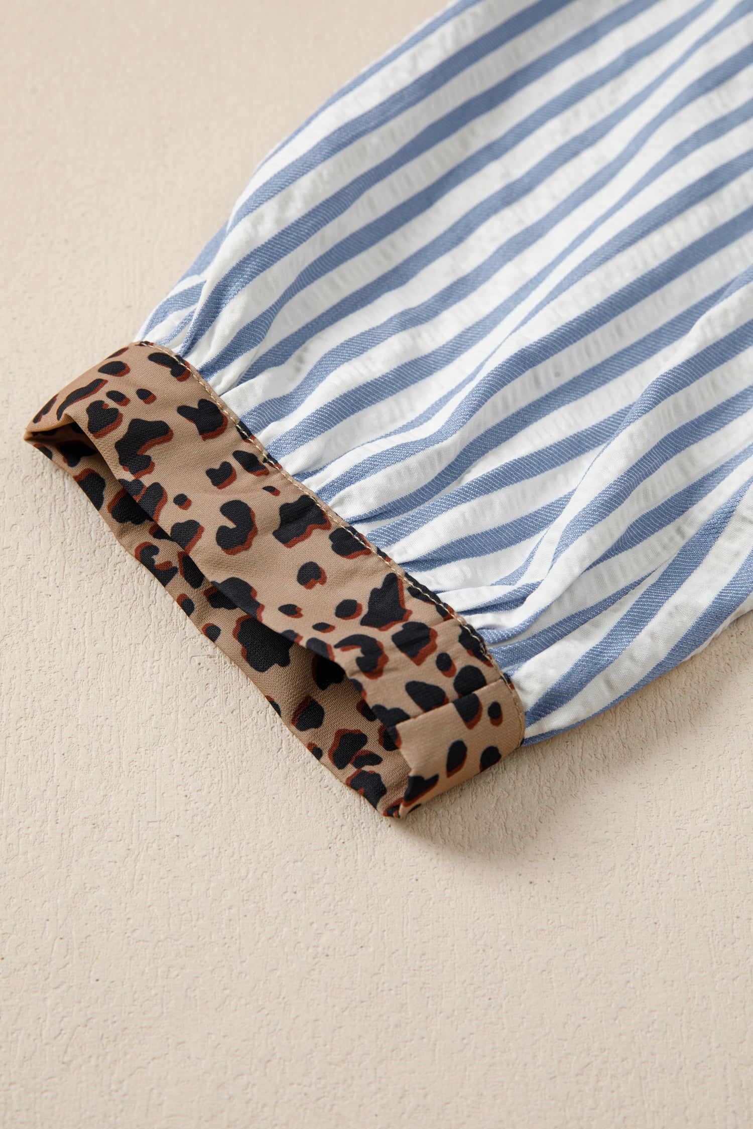 Lavendar Lane blouse with sky blue stripes, leopard trim, V-neck design, and short sleeves, stylish casual shirt for women.