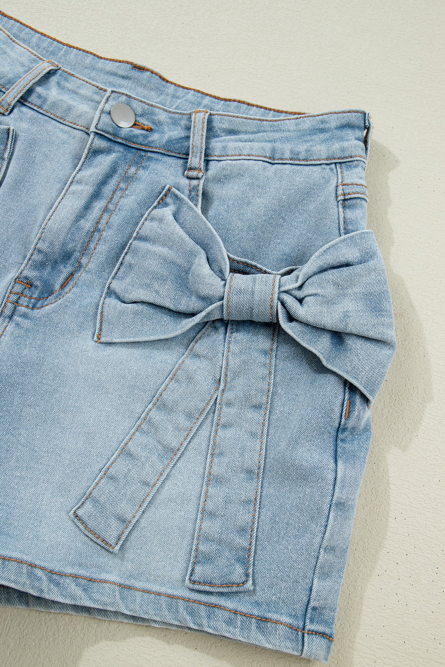 Lavendar Lane Clothing Beau Blue bow detail denim shorts with pockets, casual bottoms with stylish bow accents and functional front and back pockets.