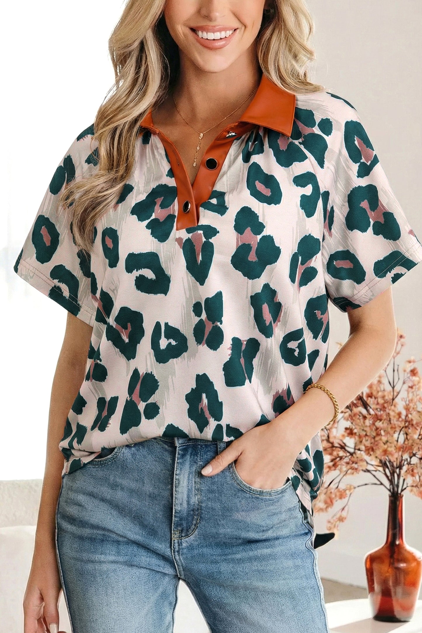 Lavendar Lane Clothing leopard print short sleeve blouse with contrast collar, button details, and casual style.