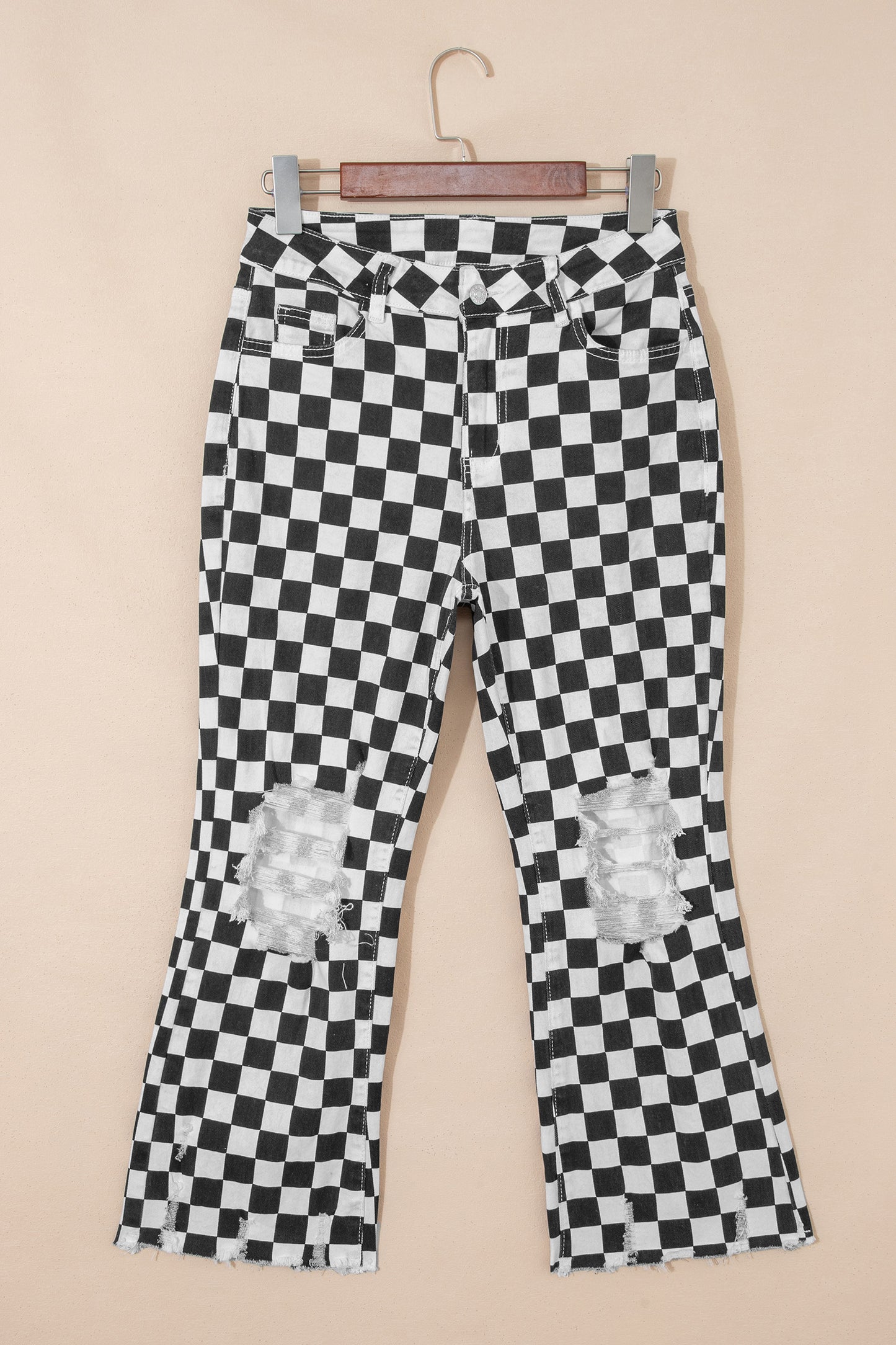 Black checkerboard print distressed raw edge cropped jeans from Lavendar Lane Clothing, showing ripped holes and frayed hems.