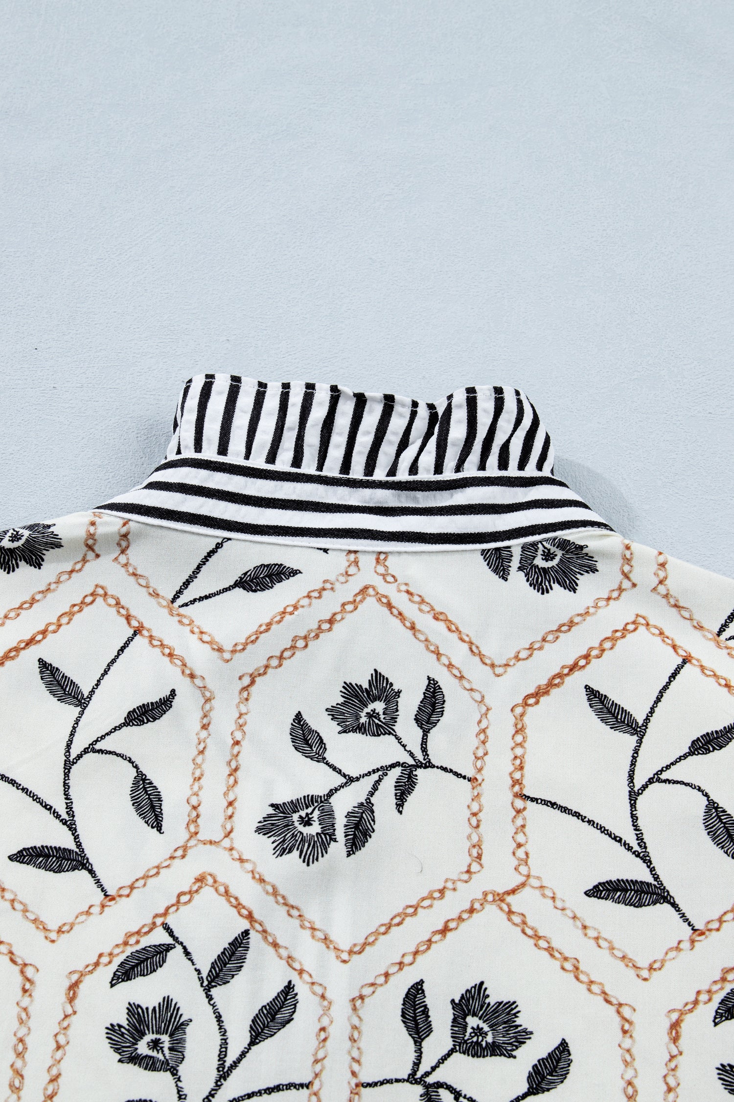 White floral print striped patchwork blouse by Lavendar Lane Clothing with button-up front and short sleeves.