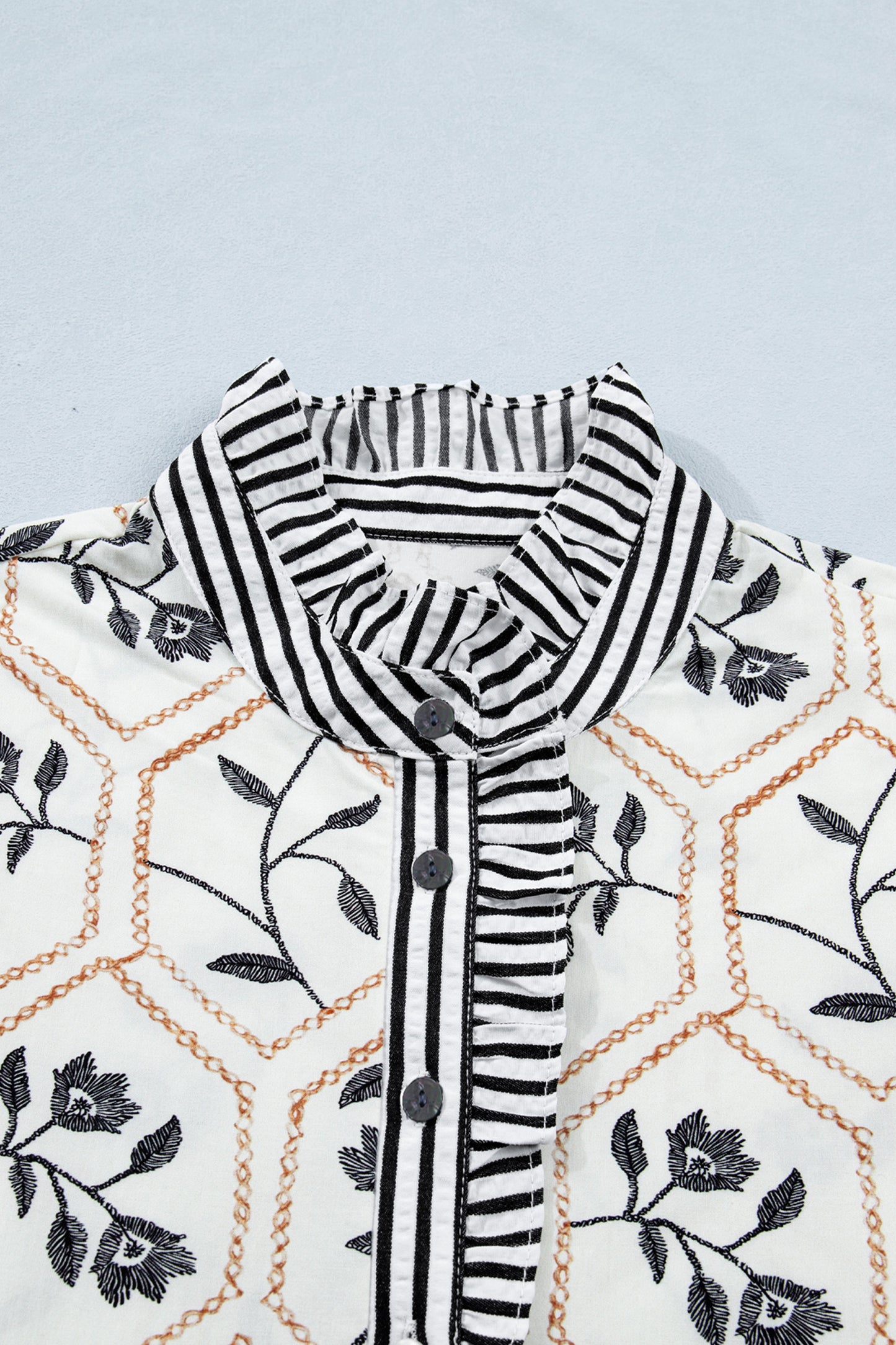 White floral print striped patchwork blouse by Lavendar Lane Clothing with button neckline and short sleeves.