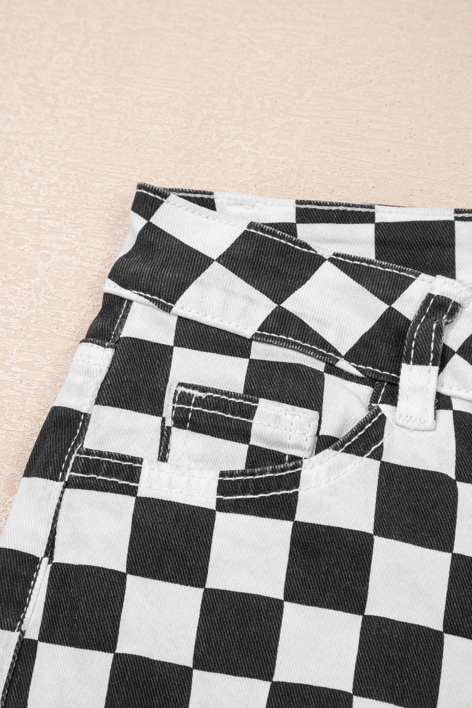 Black checkerboard print distressed raw edge cropped jeans from Lavendar Lane Clothing, showing the raw hem and distressed details.