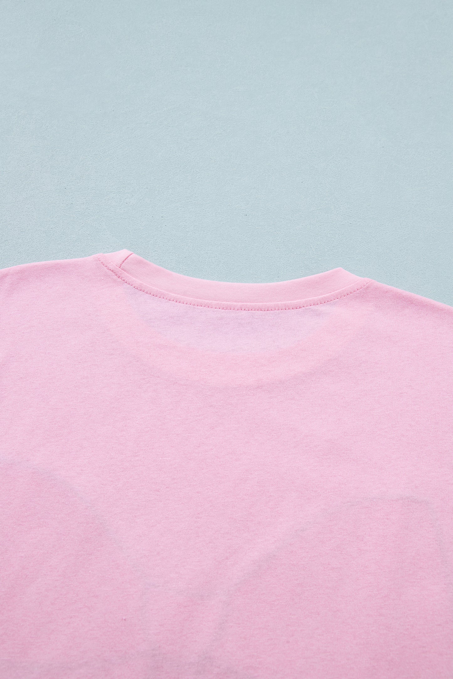 Pink leopard embroidered cotton round neck T-shirt by Lavendar Lane Clothing, featuring a playful bow and soft fabric.