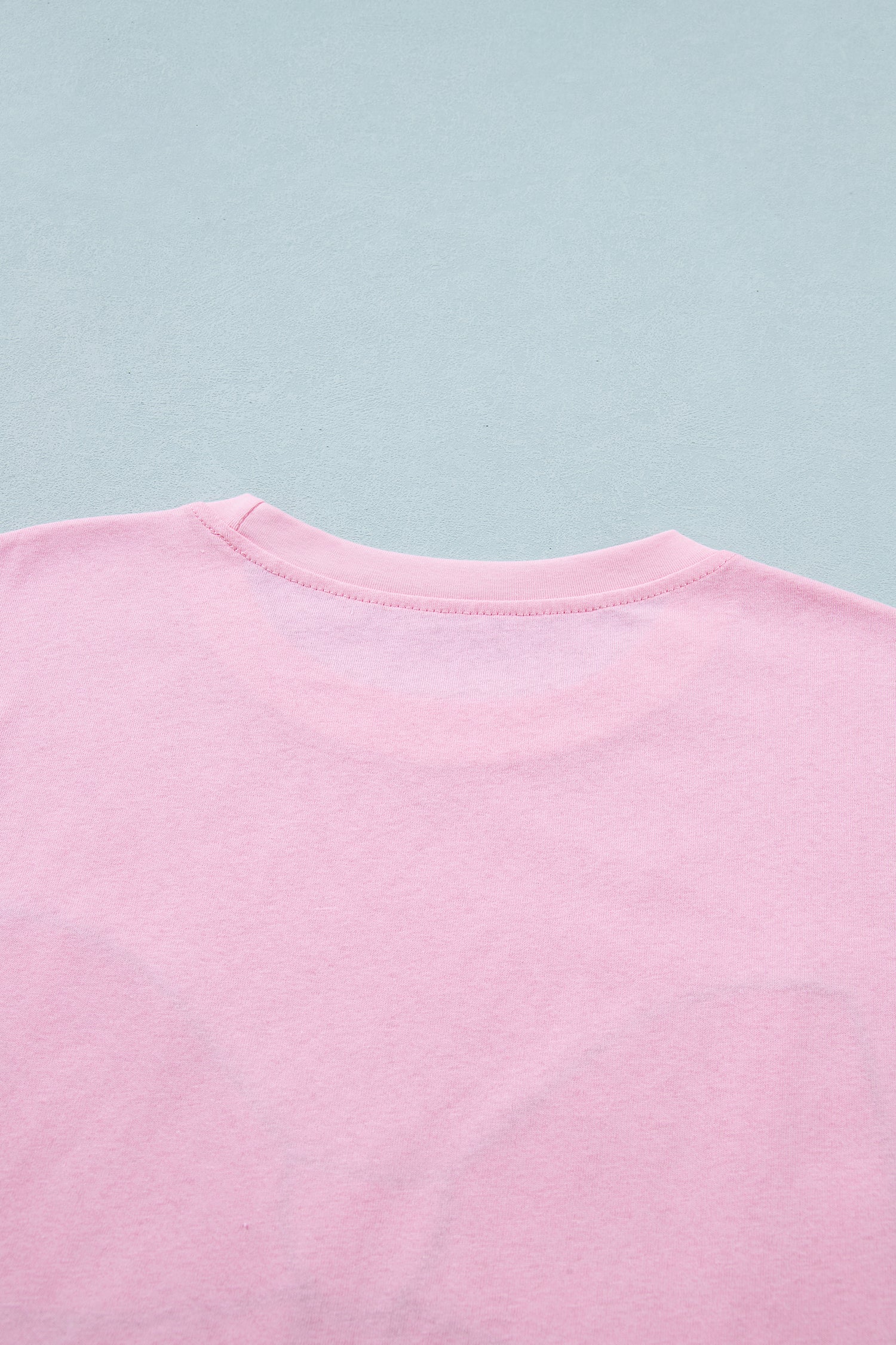 Pink leopard embroidered cotton round neck T-shirt by Lavendar Lane Clothing, featuring a playful bow and soft fabric.