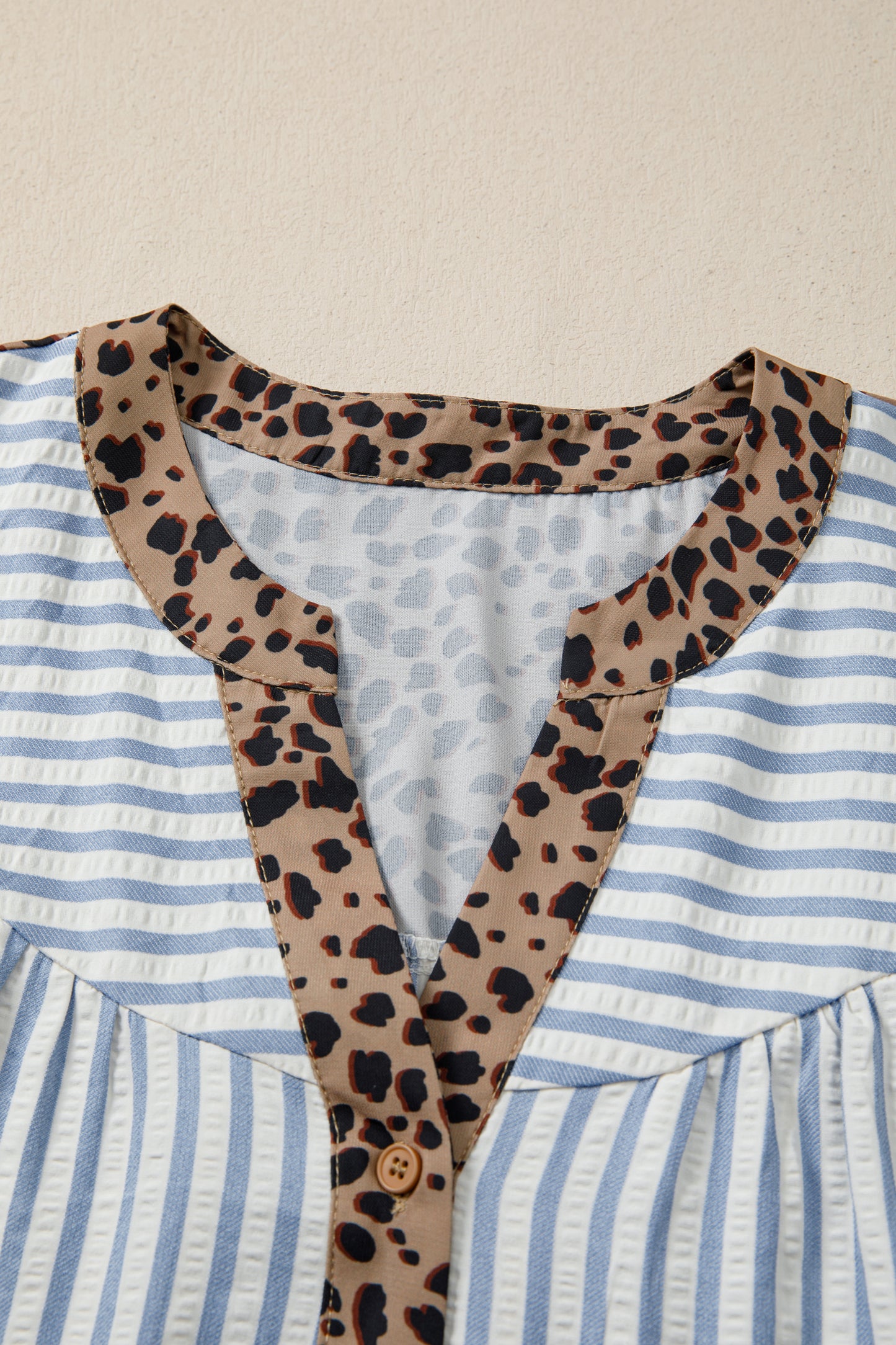 Sky blue stripe leopard trim V-neck button-down blouse by Lavendar Lane Clothing with half sleeves and stylish design.