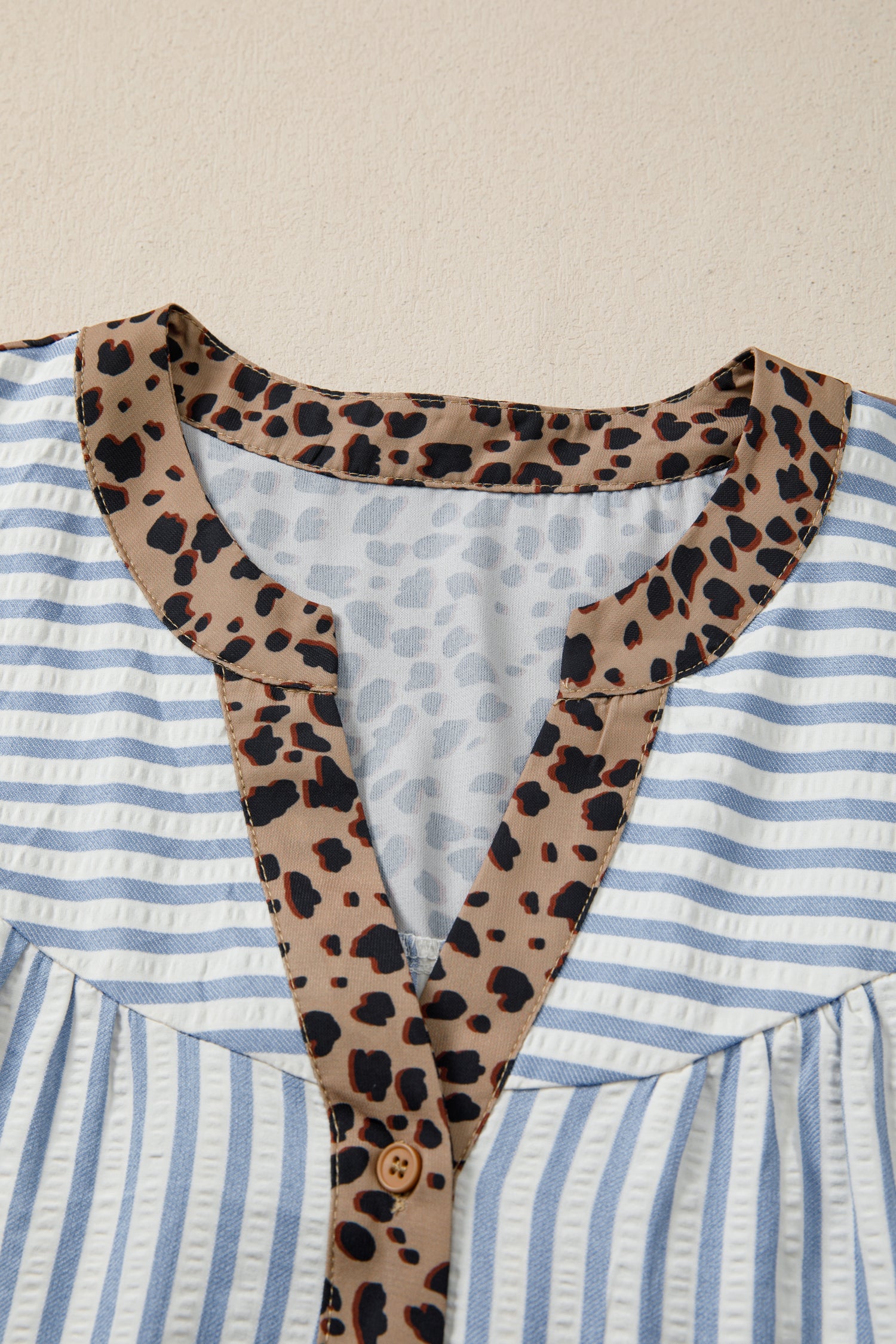 Sky blue stripe leopard trim V-neck button-down blouse by Lavendar Lane Clothing with half sleeves and stylish design.