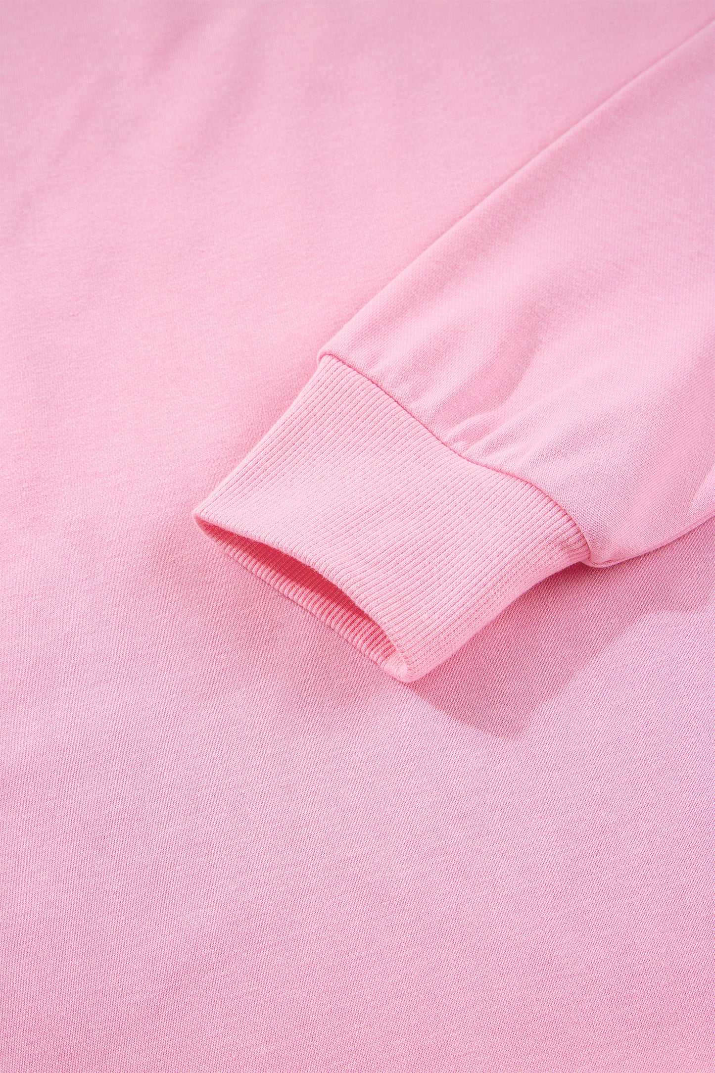 Pink sequin bow and XOXO letter graphic baggy sweatshirt by Lavendar Lane Clothing, featuring exposed seams and relaxed fit.
