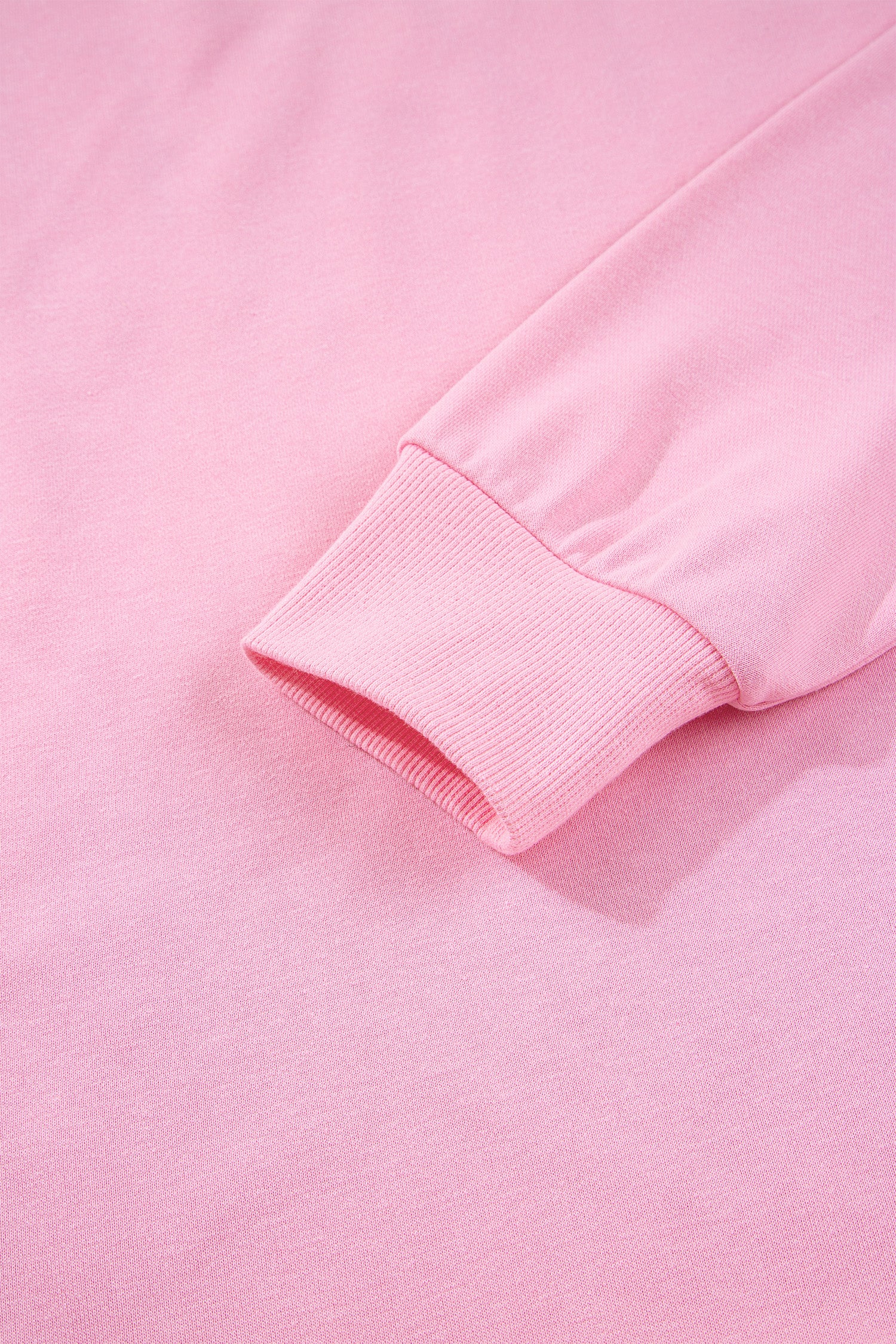 Pink sequin bow and XOXO letter graphic baggy sweatshirt by Lavendar Lane Clothing, featuring exposed seams and relaxed fit.
