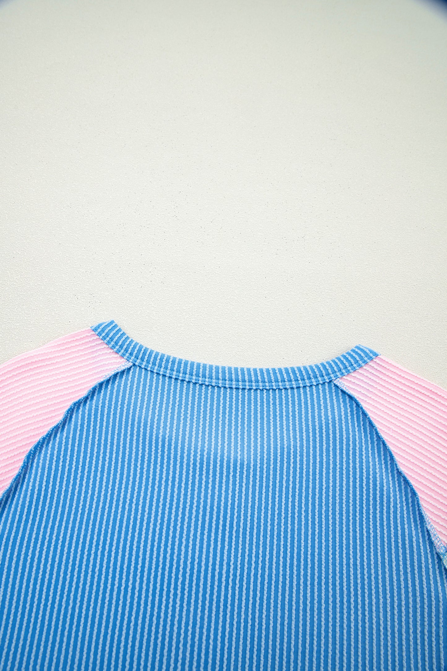 Blue twisted ribbed color block patchwork Henley blouse by Lavendar Lane Clothing, featuring short sleeves and a stylish design.